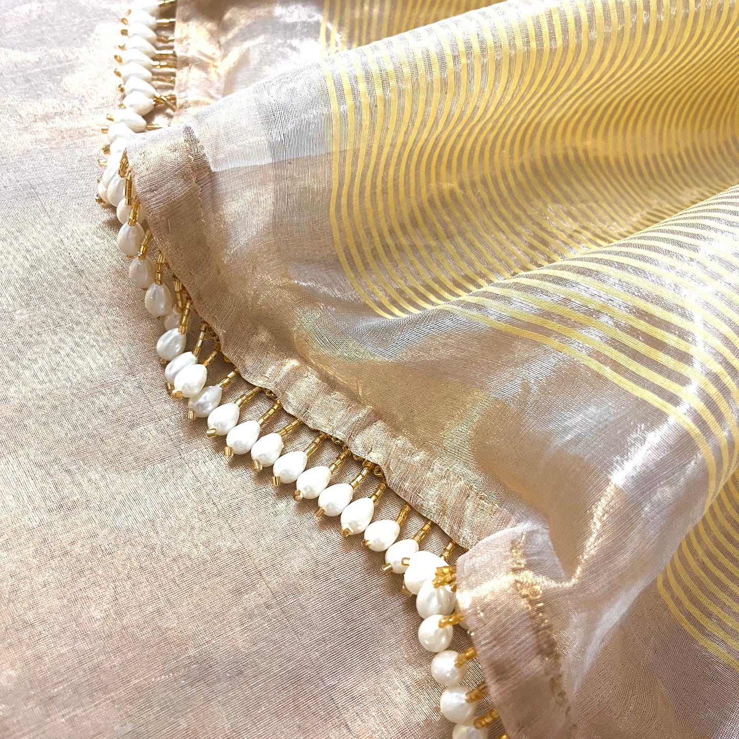 Molten gold chanderi tissue silk saree with dangling pearl border