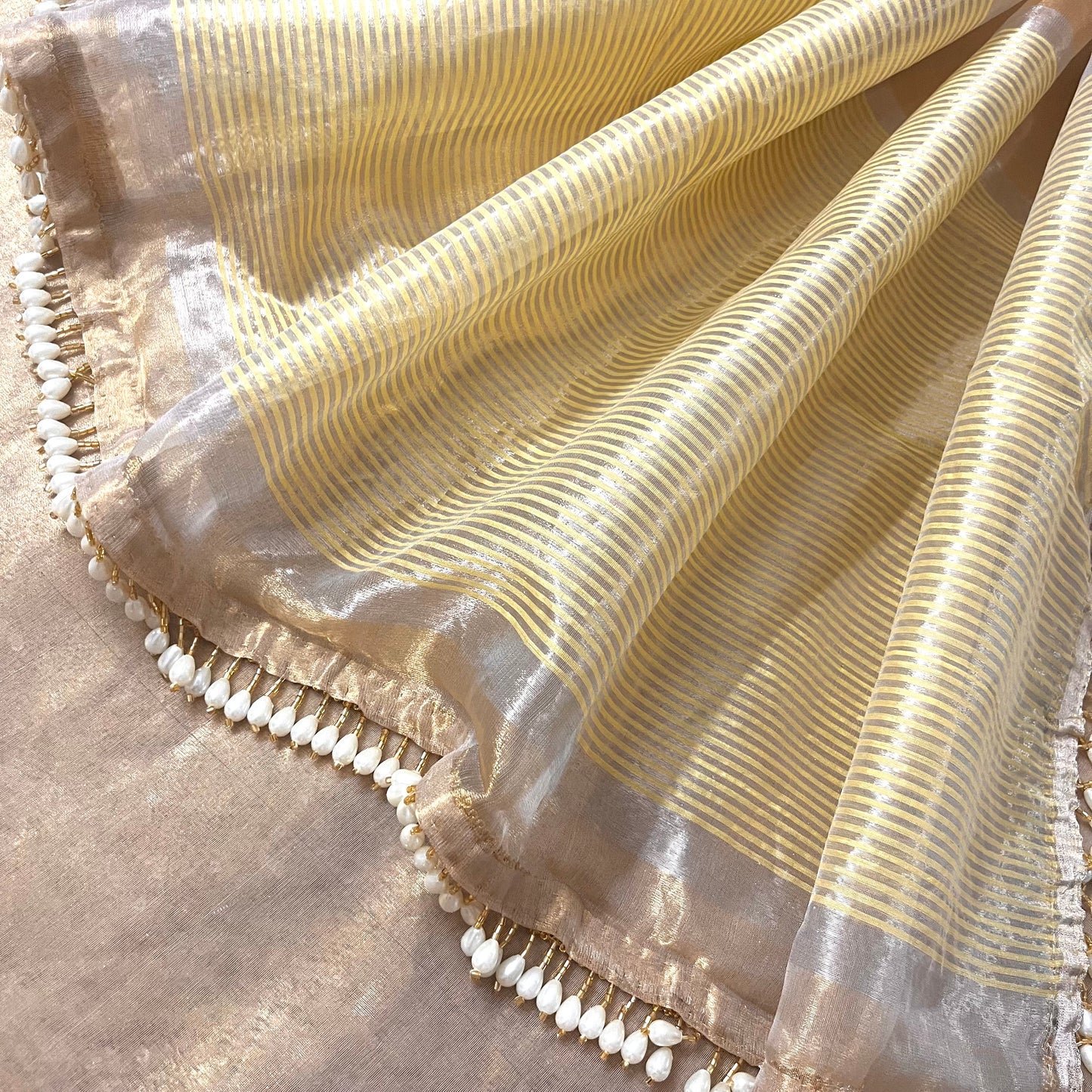 Molten gold chanderi tissue silk saree with dangling pearl border