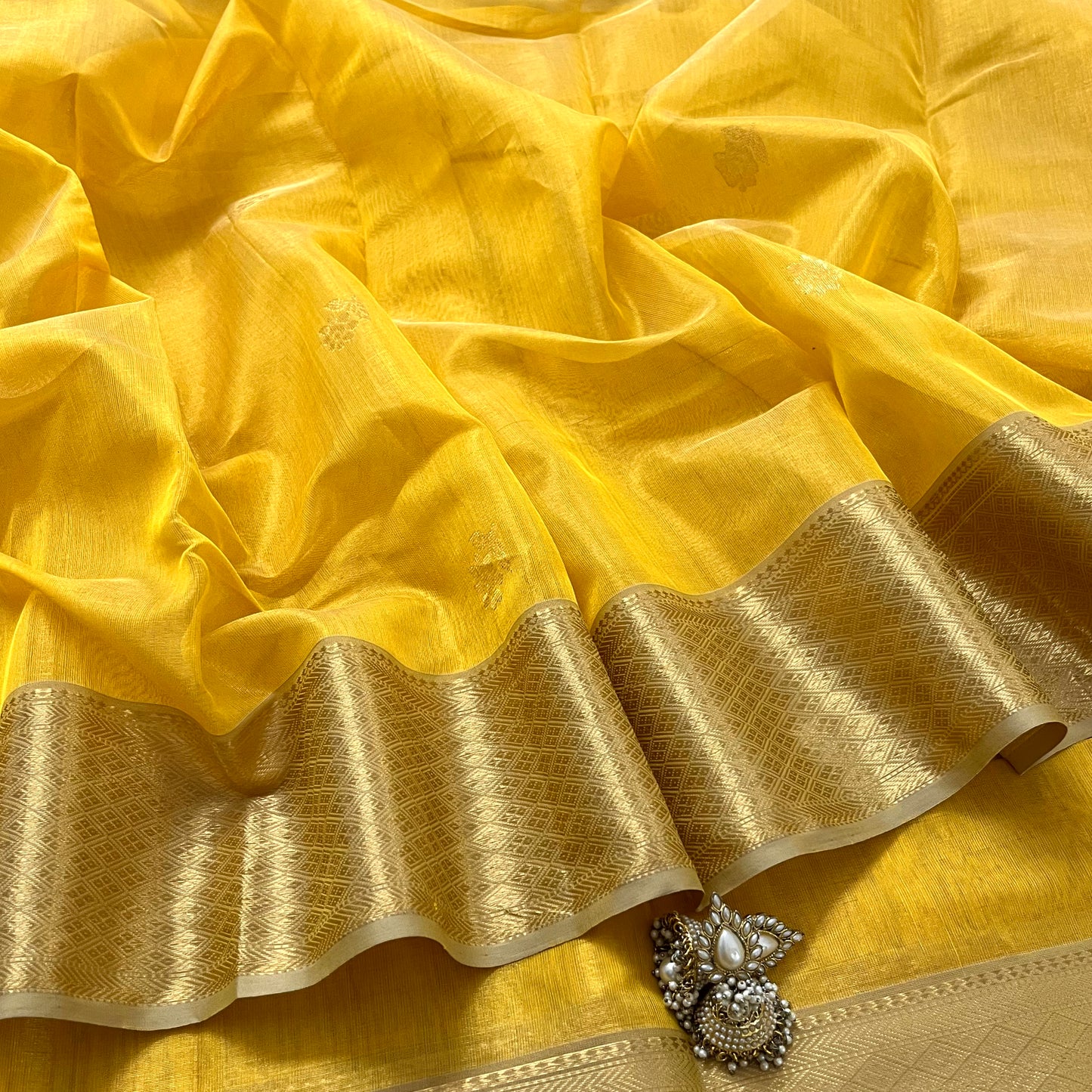 Yellow maheshwari tissue silk saree with flower motifs all over