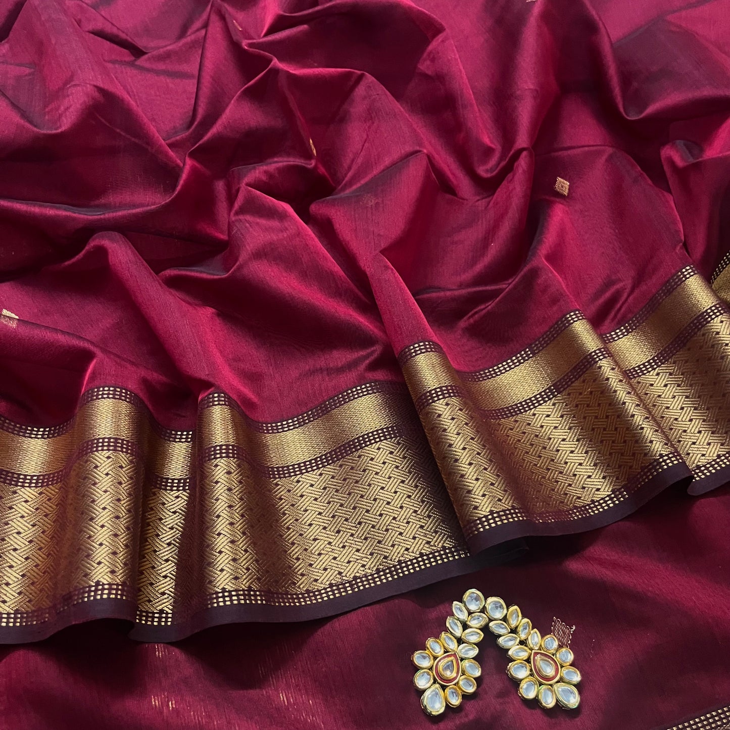 Deep maroon Maheshwari saree with zari motifs on pallu