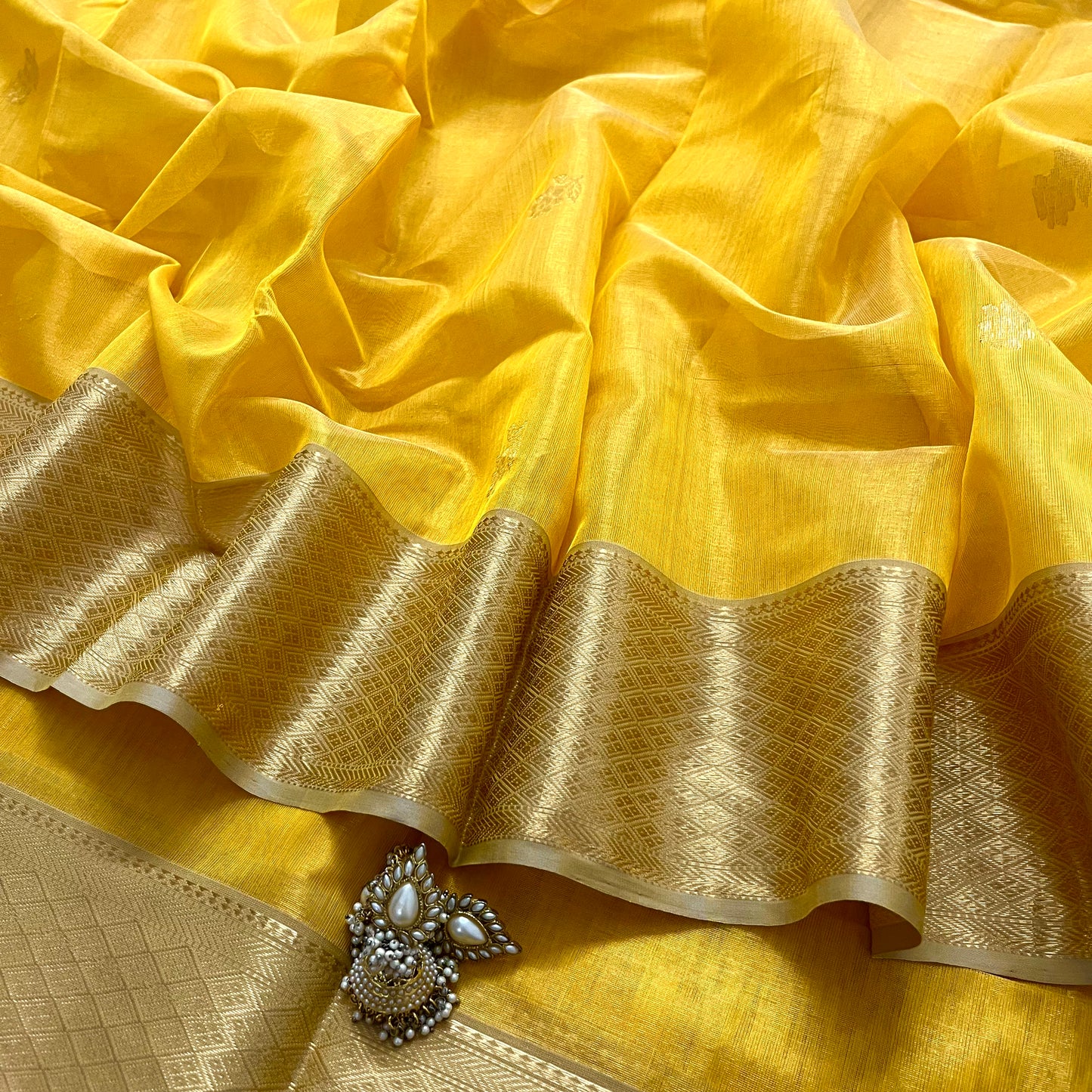 Yellow maheshwari tissue silk saree with flower motifs all over