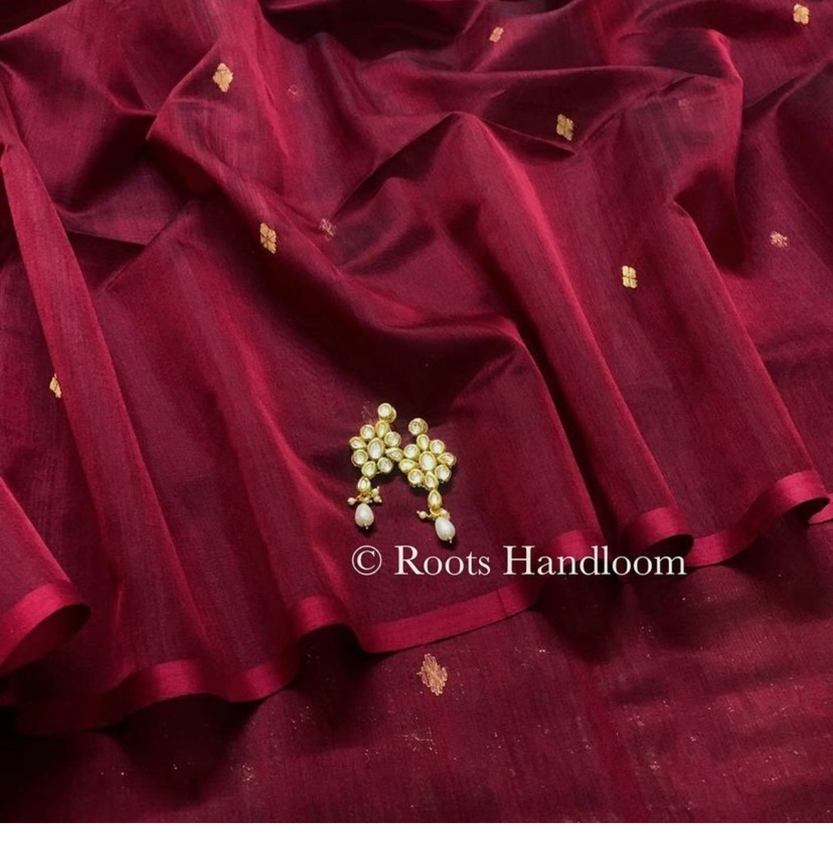 Deep maroon Maheshwari saree with zari bootis all over