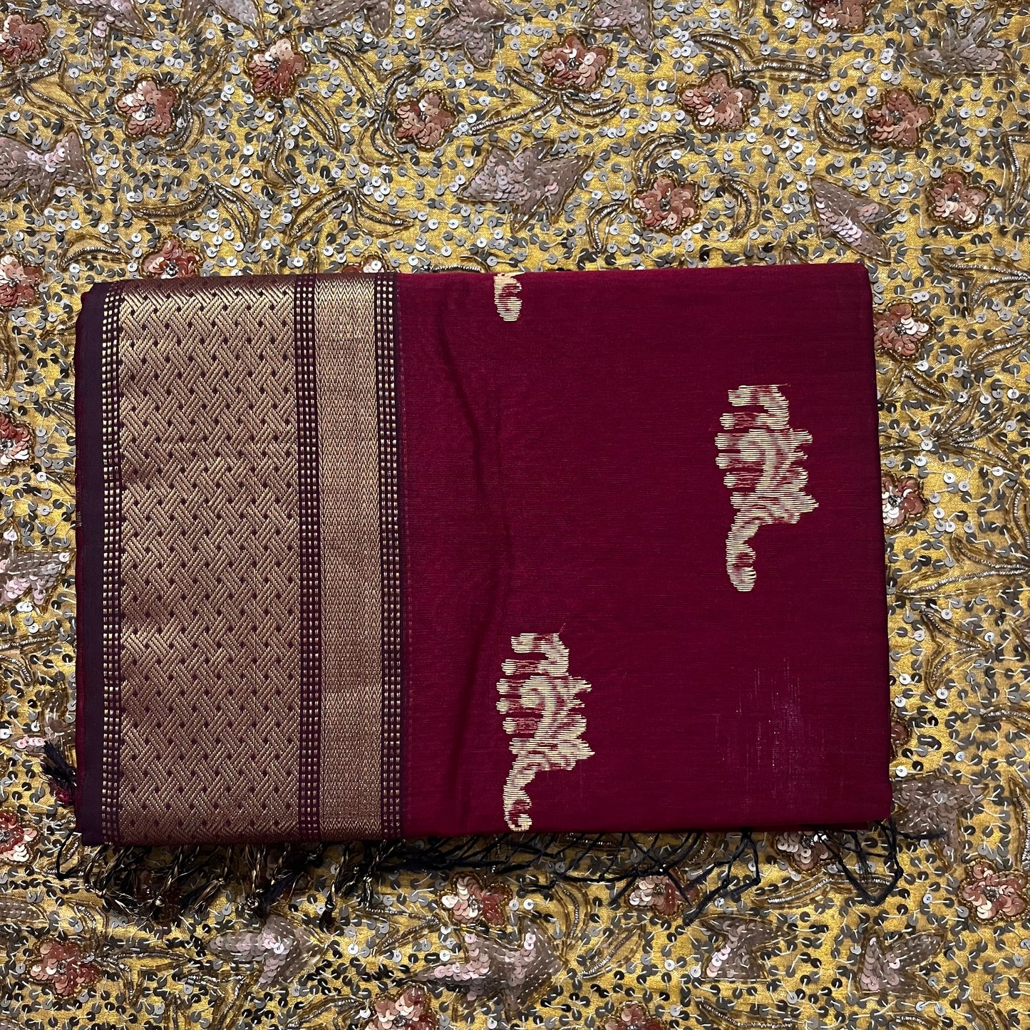 Deep maroon Maheshwari saree with zari motifs on pallu