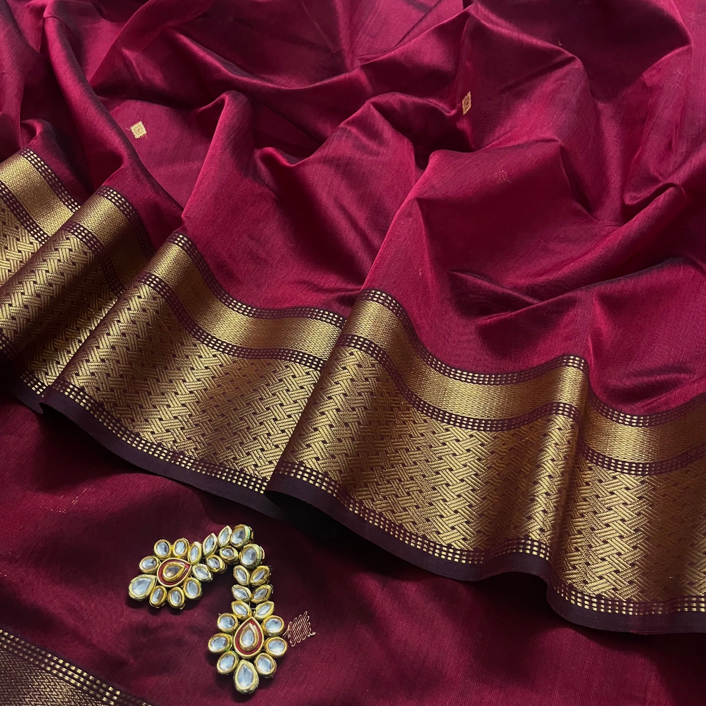 Deep maroon Maheshwari saree with zari motifs on pallu