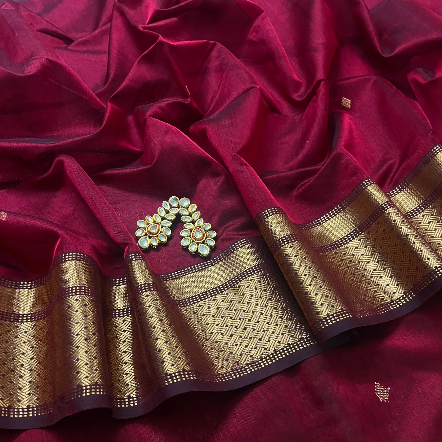 Deep maroon Maheshwari saree with zari motifs on pallu