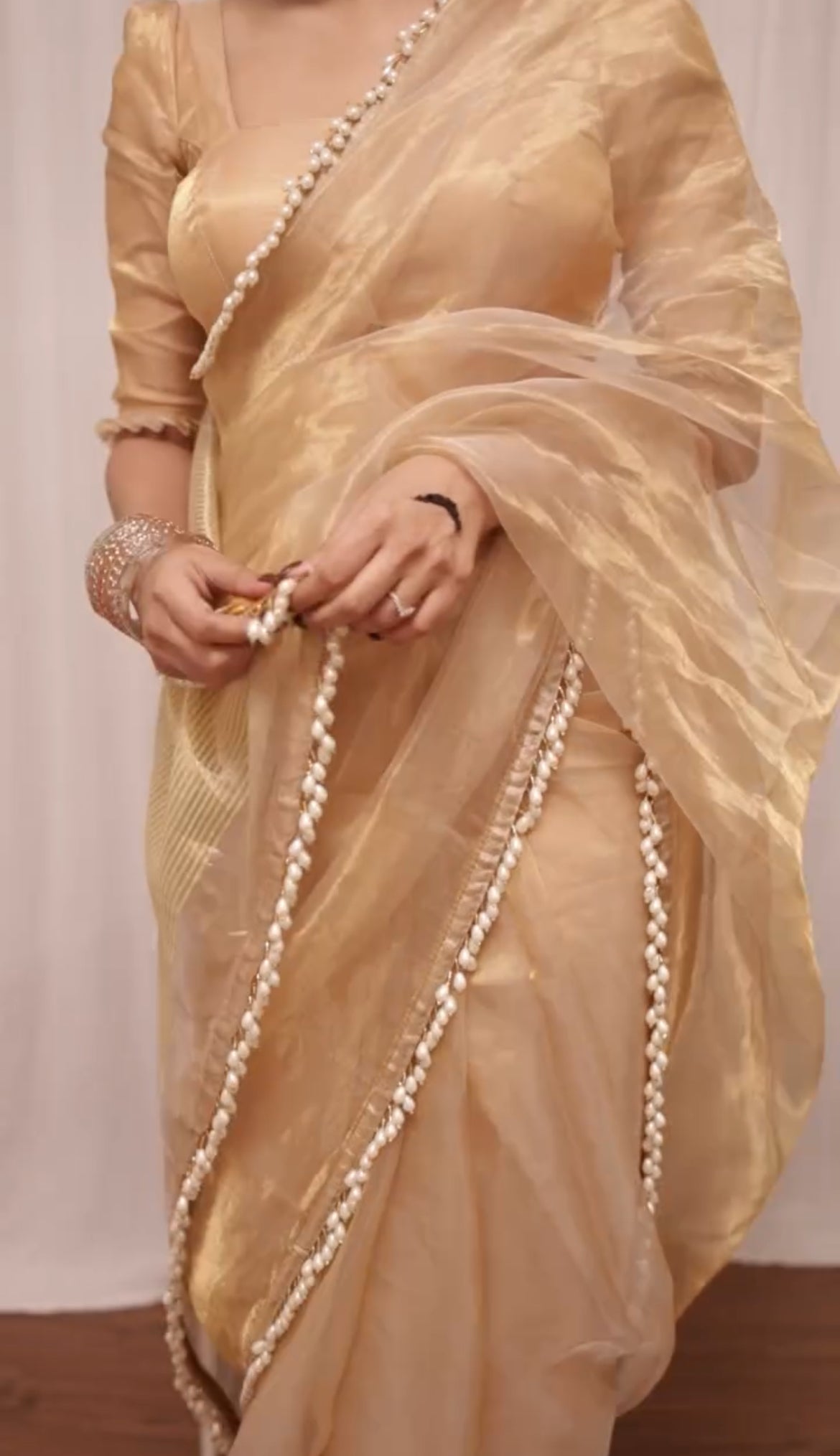 Molten gold chanderi tissue silk saree with dangling pearl border