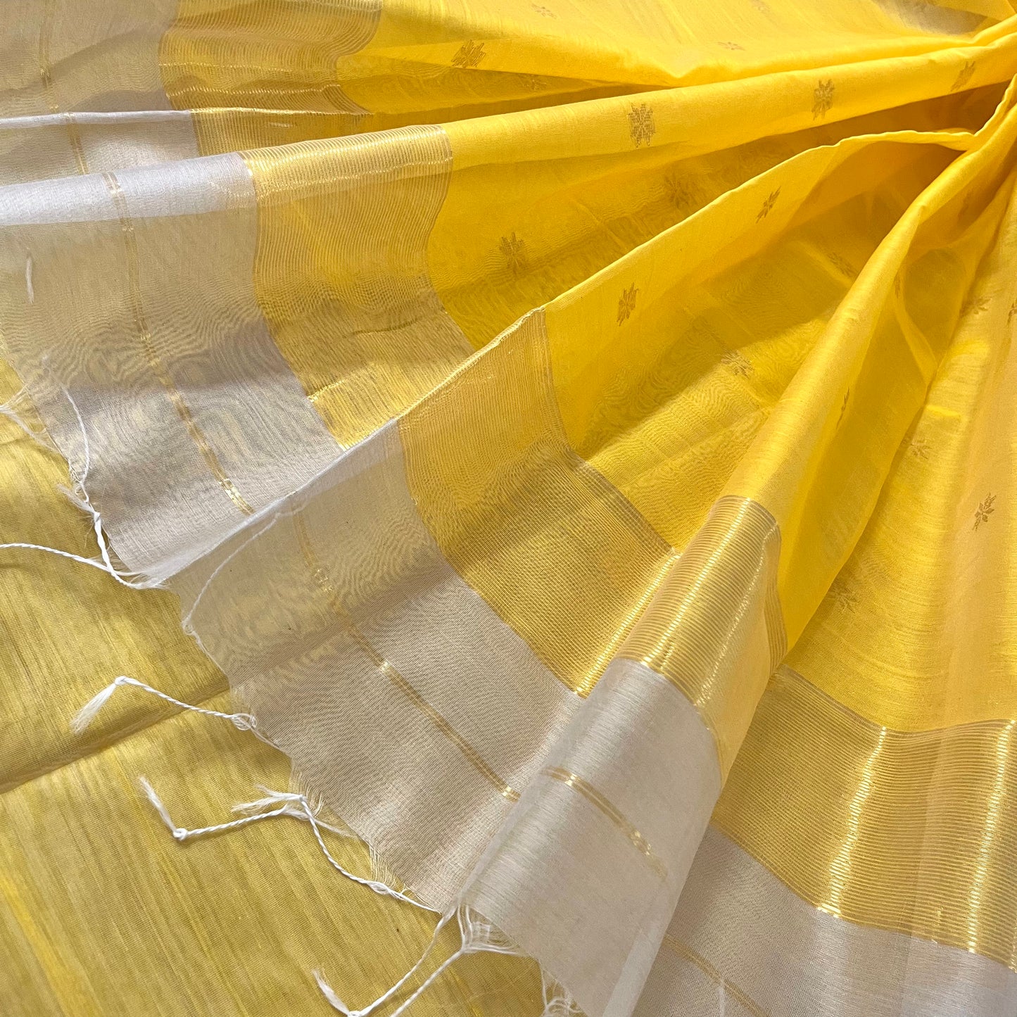 Light beige and yellow maheshwari saree with flower bootis all over