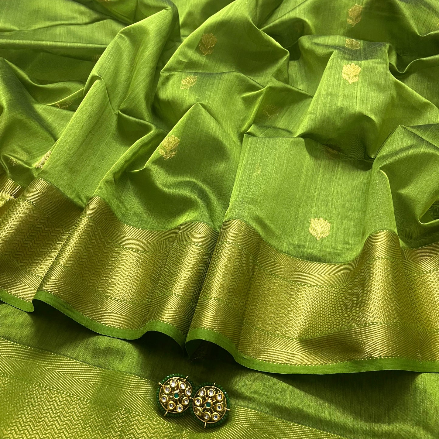 Olive green maheshwari saree with flower motifs all over