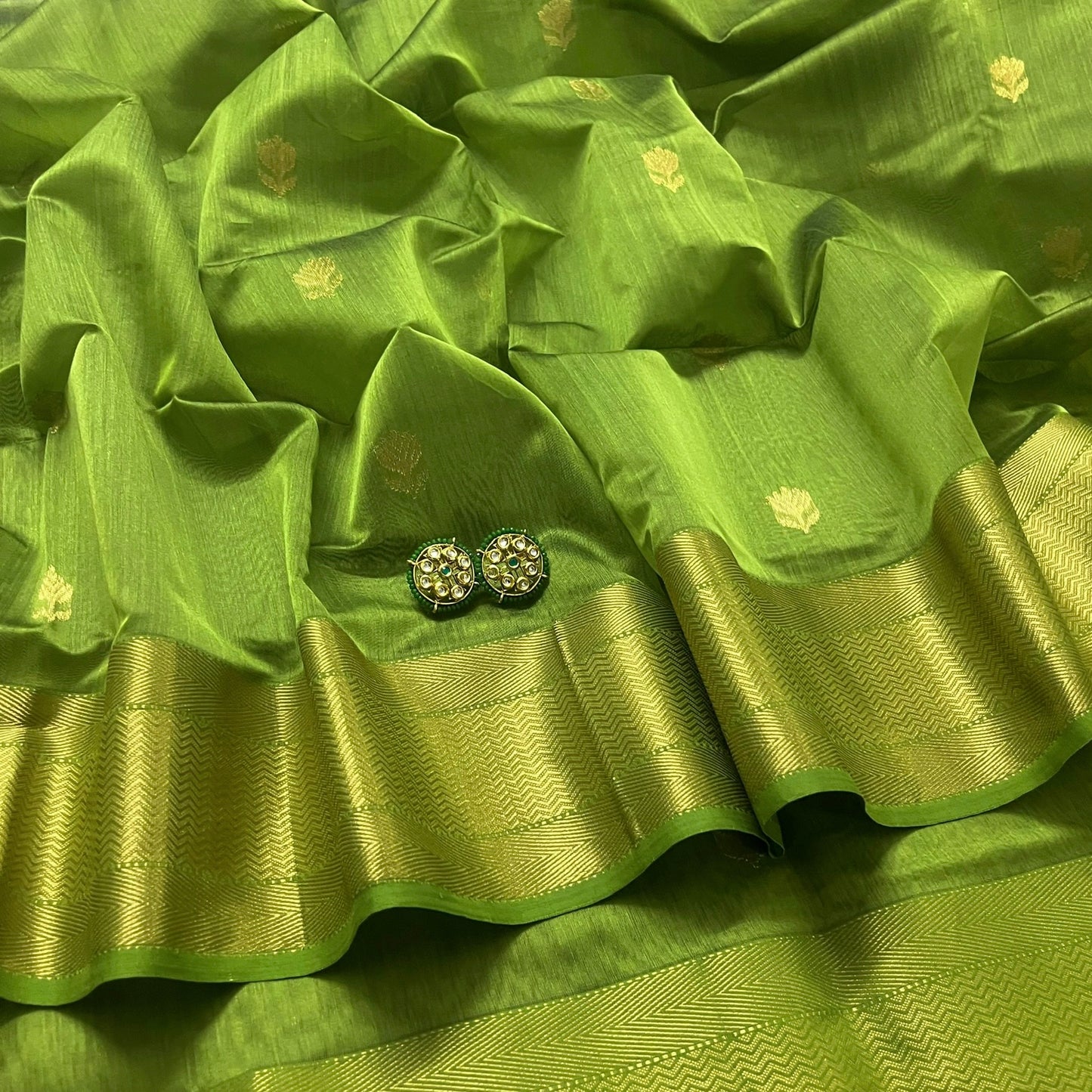 Olive green maheshwari saree with flower motifs all over