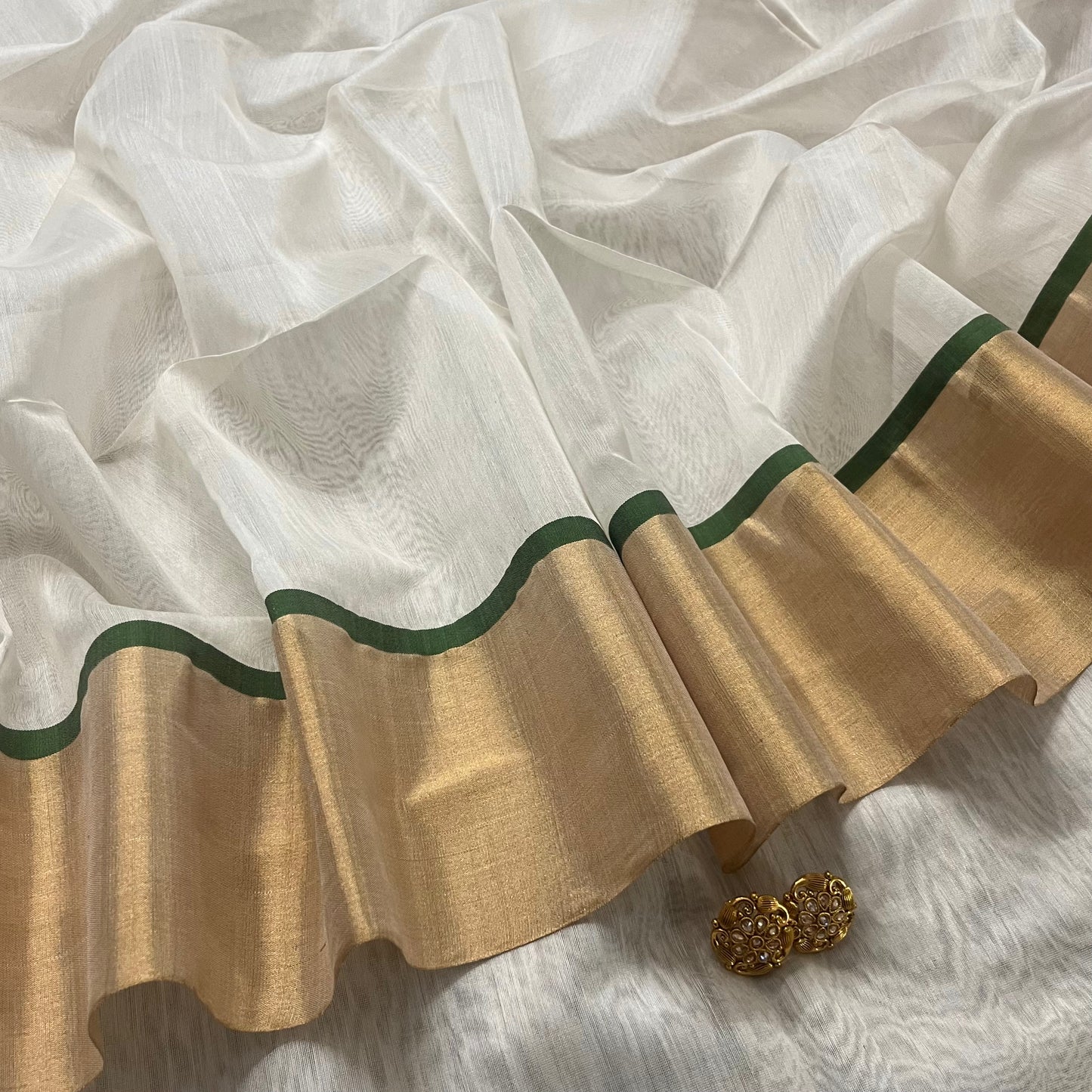 Off white and green maheshwari saree with zari lines on pallu