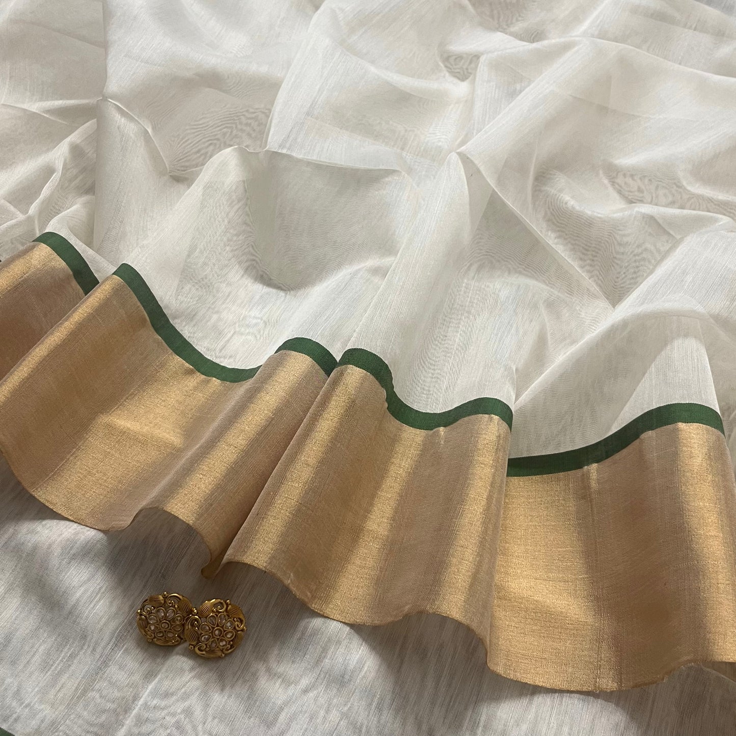 Off white and green maheshwari saree with zari lines on pallu