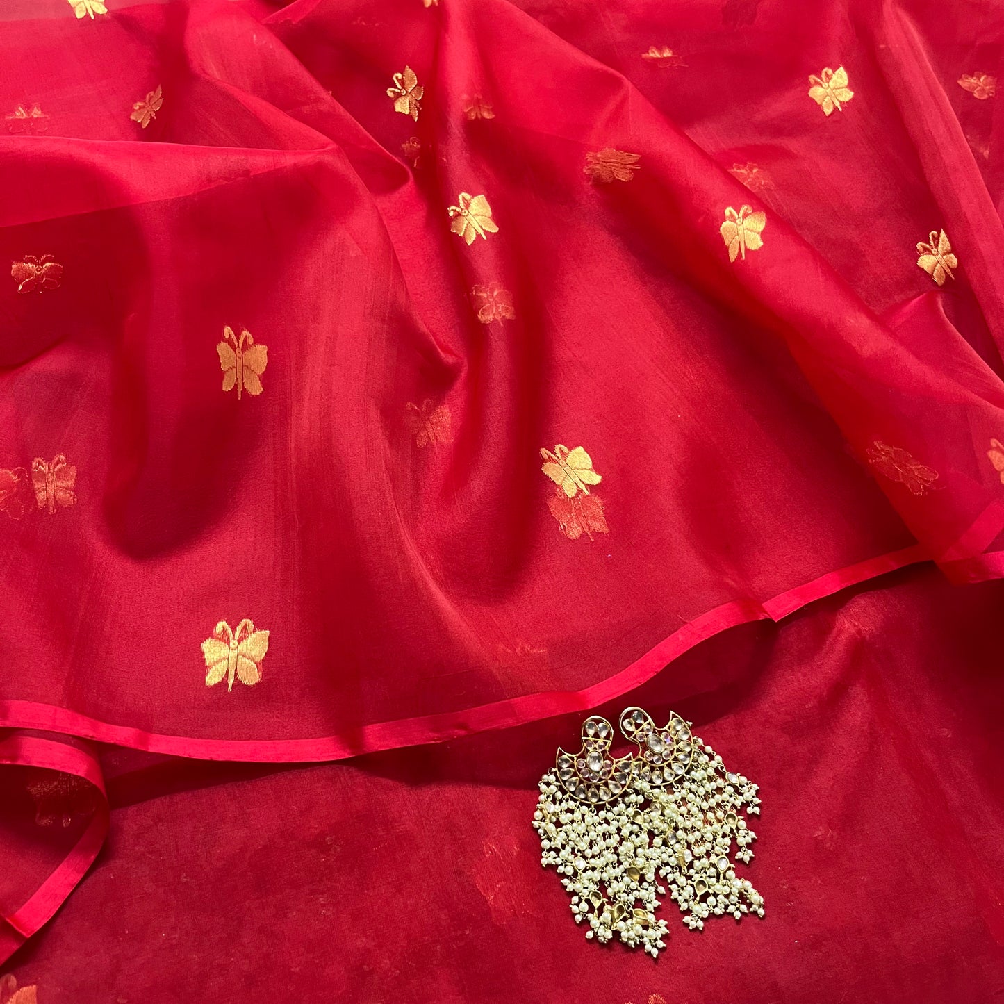 Red chanderi organza silk saree with butterfly motifs all over