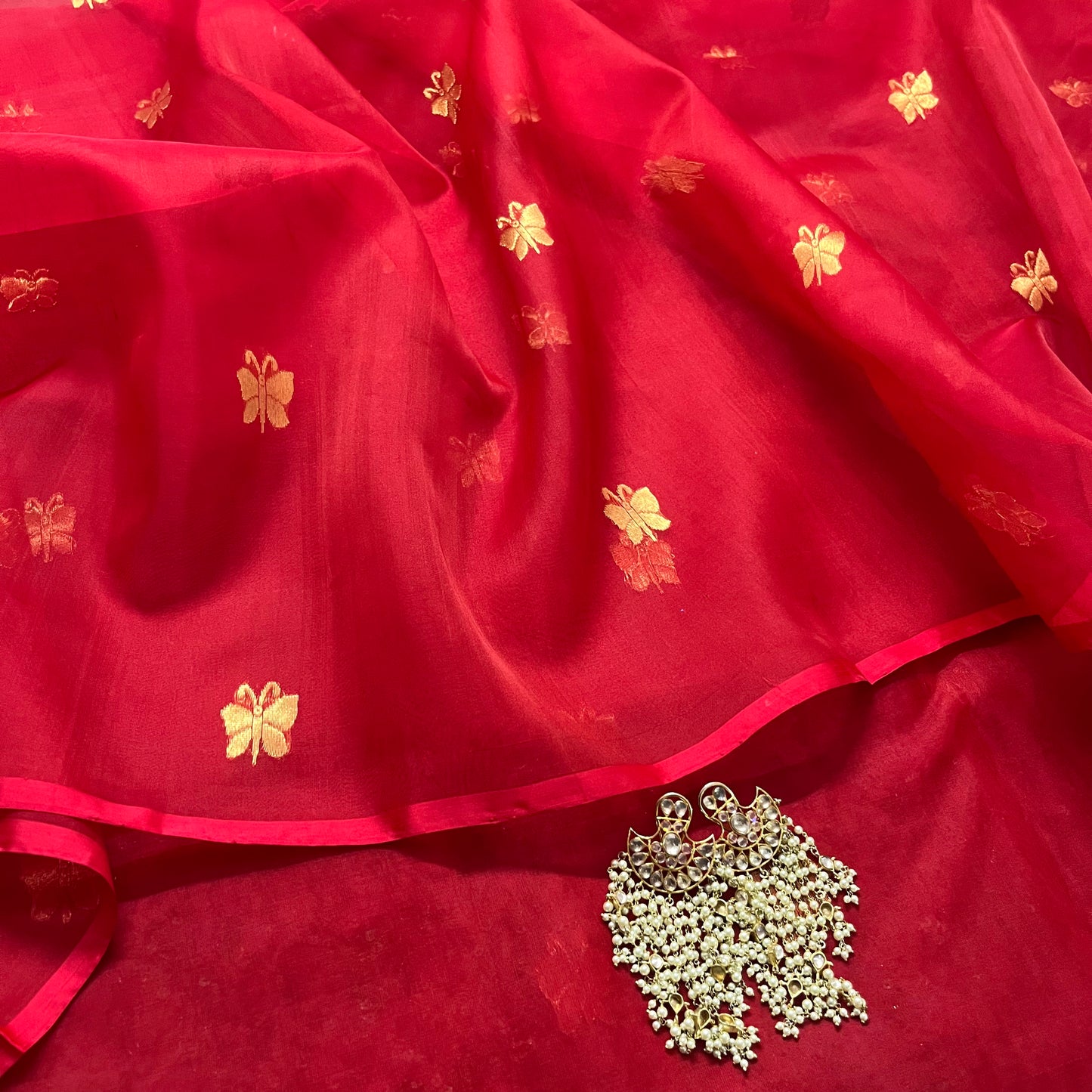 Red chanderi organza silk saree with butterfly motifs all over