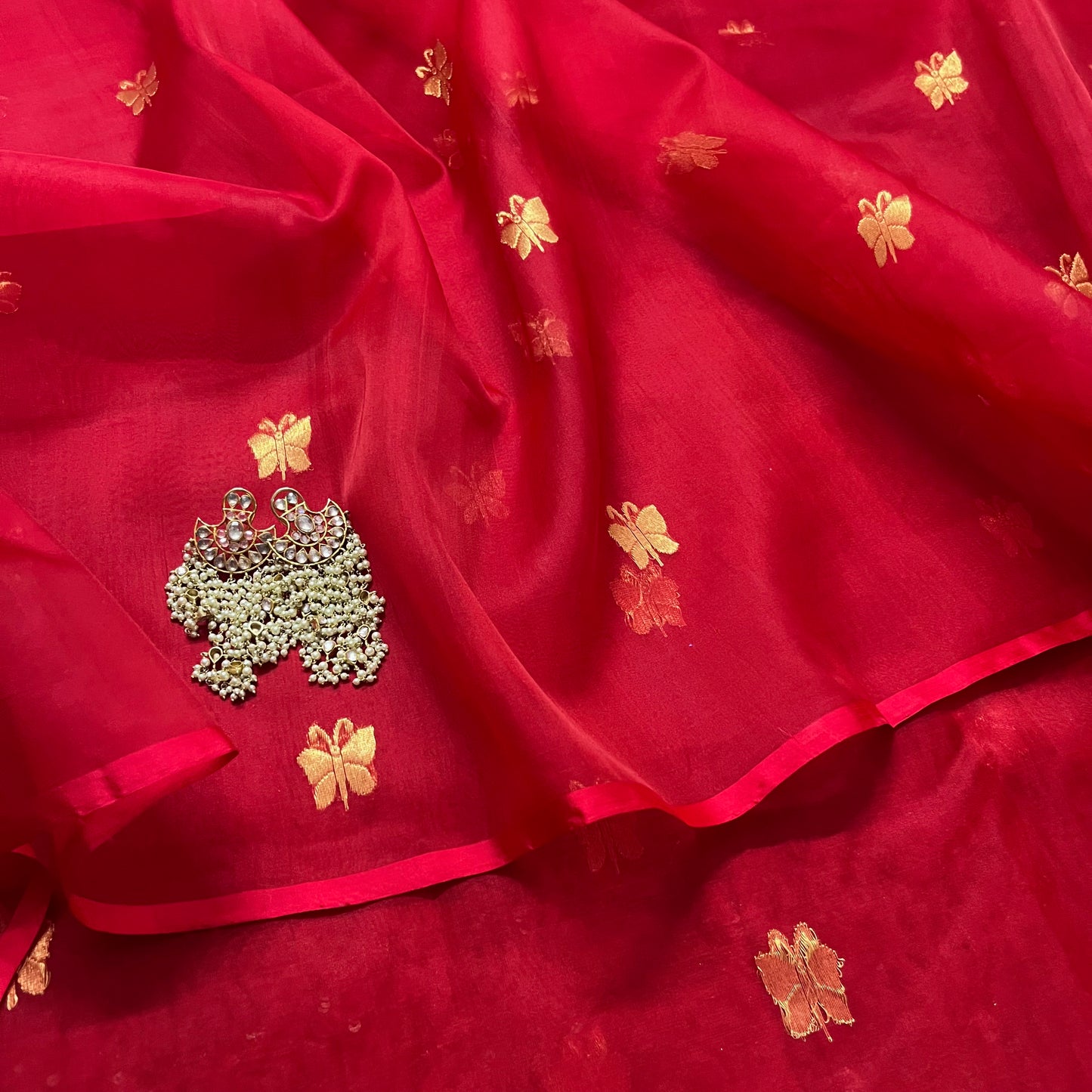 Red chanderi organza silk saree with butterfly motifs all over