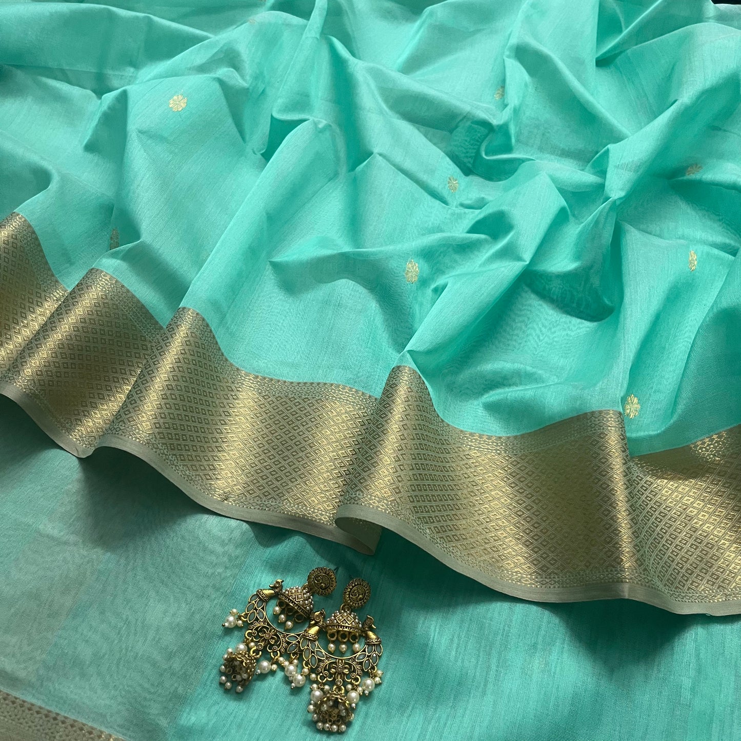 Tiffany green and beige maheshwari saree with flower motifs on pallu