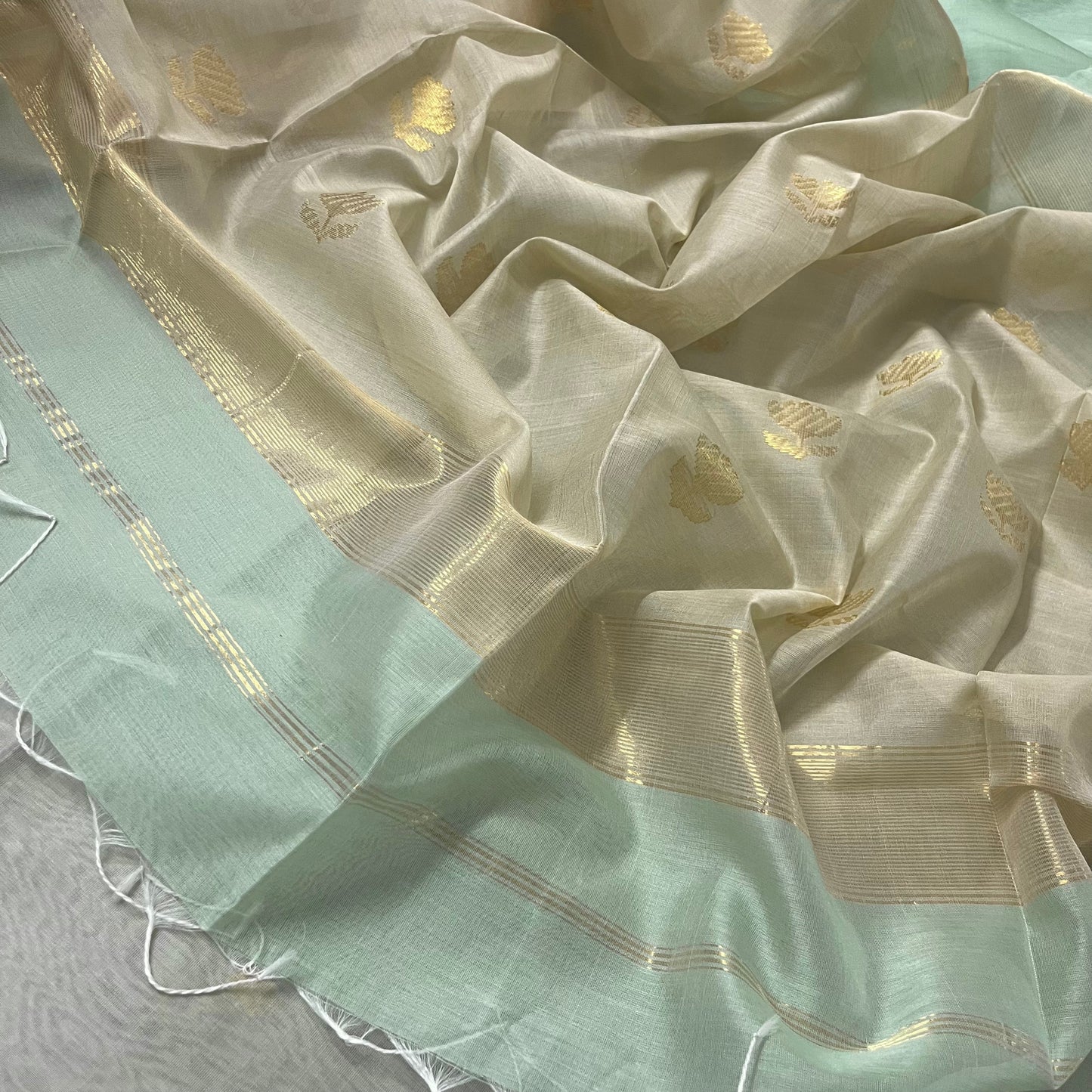 Light green and beige maheshwari saree with flower motifs on pallu