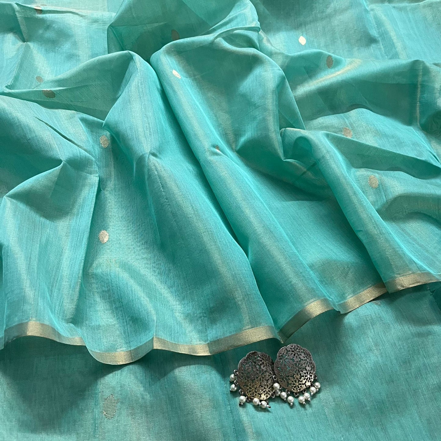 Turquoise maheshwari tissue silk saree with zari bootis all over