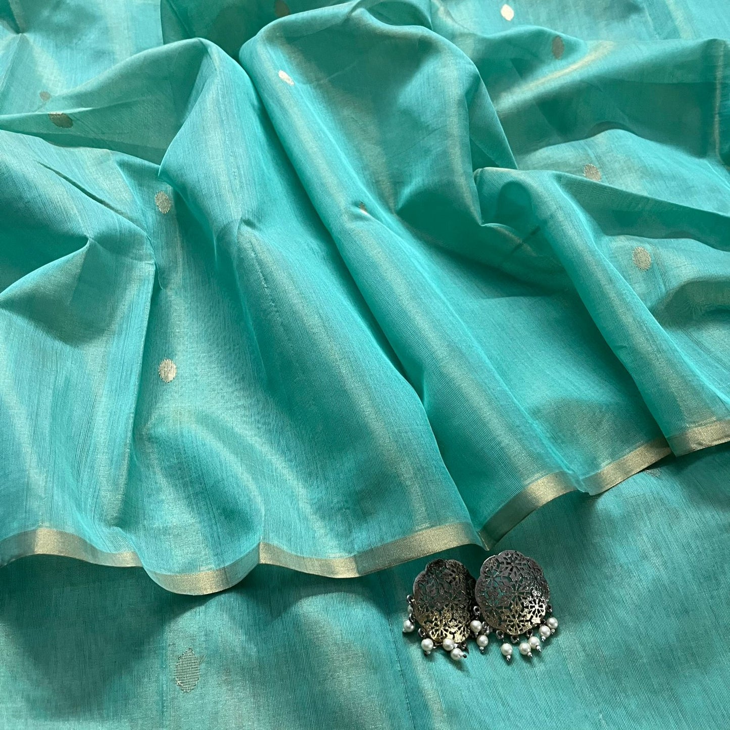 Turquoise maheshwari tissue silk saree with zari bootis all over