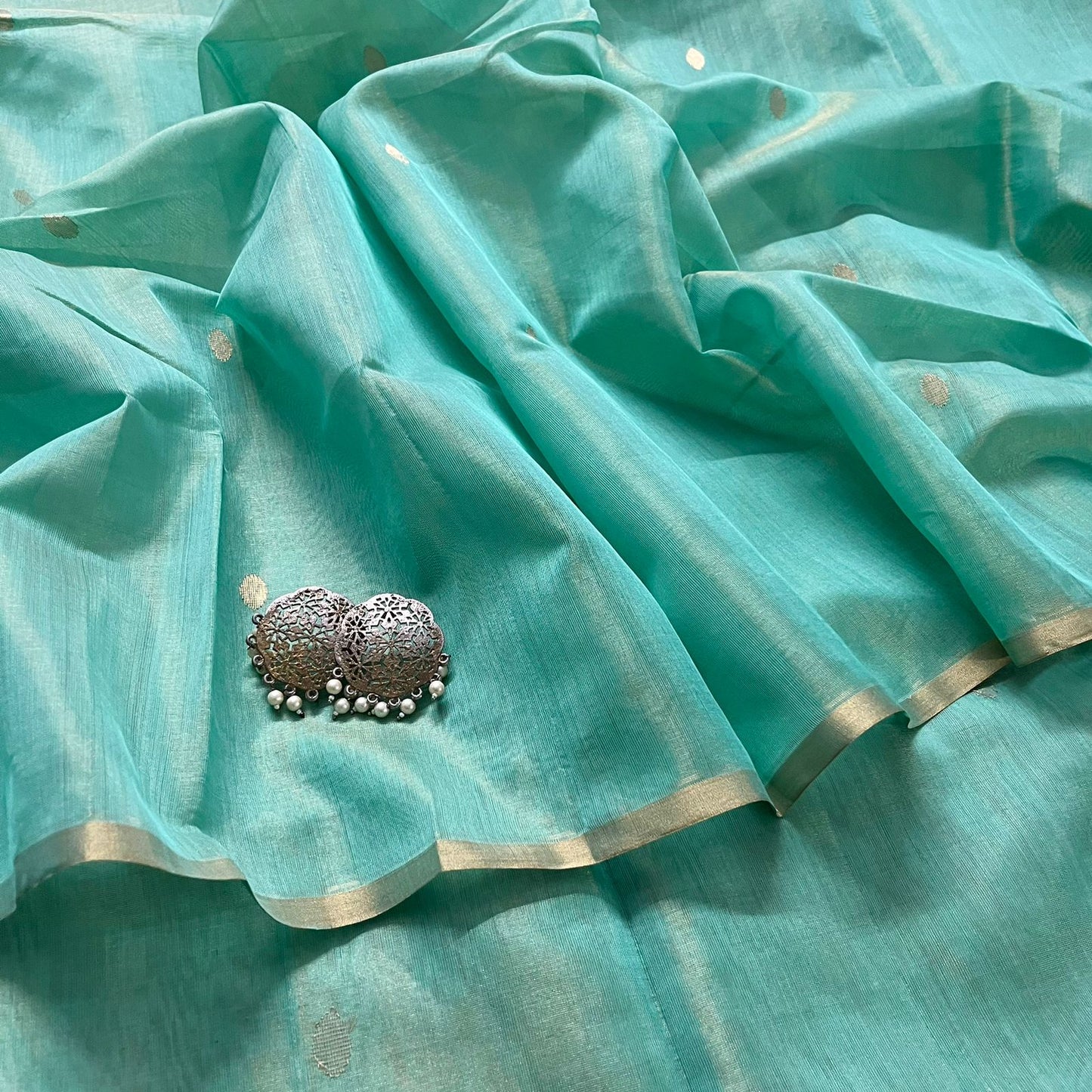 Turquoise maheshwari tissue silk saree with zari bootis all over