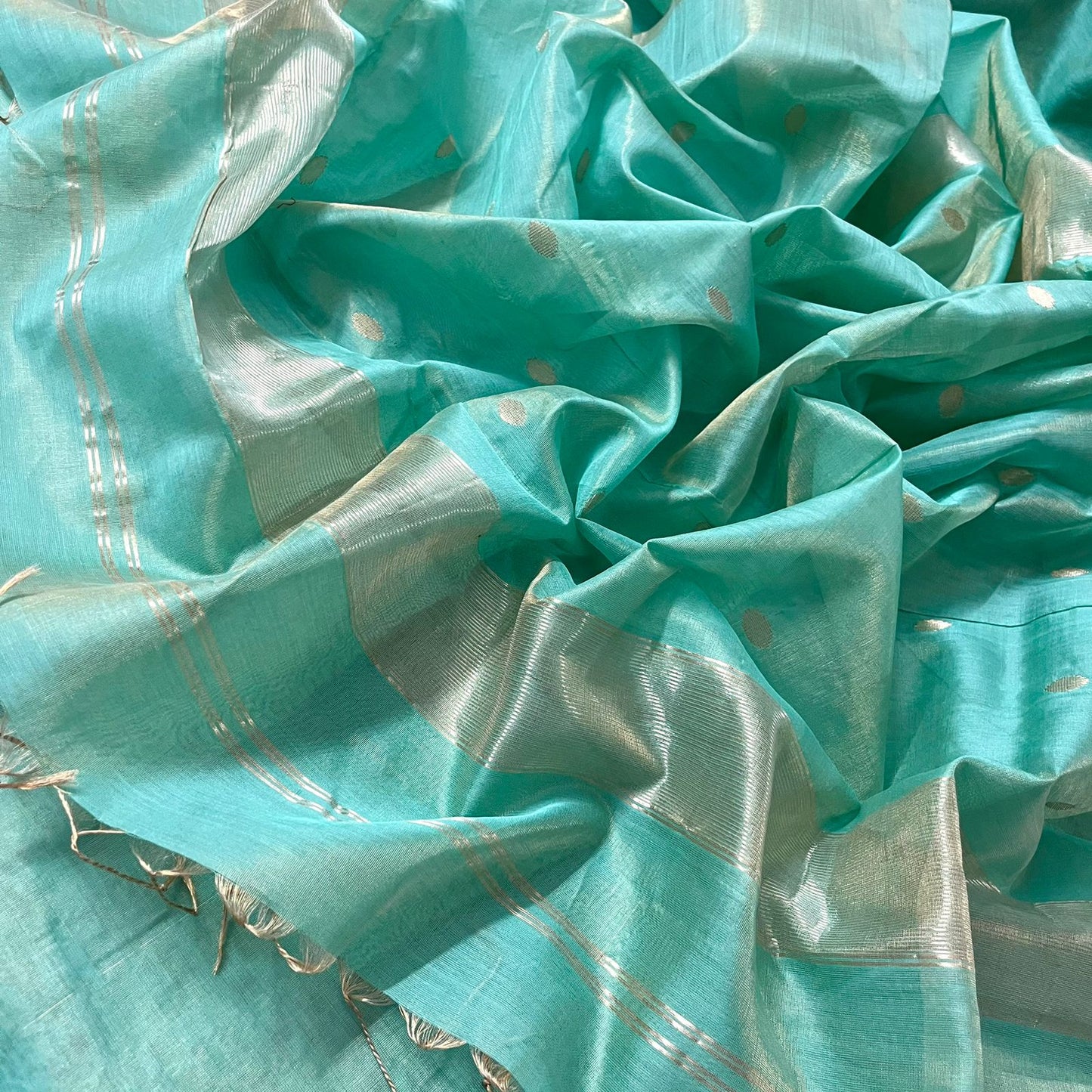 Turquoise maheshwari tissue silk saree with zari bootis all over