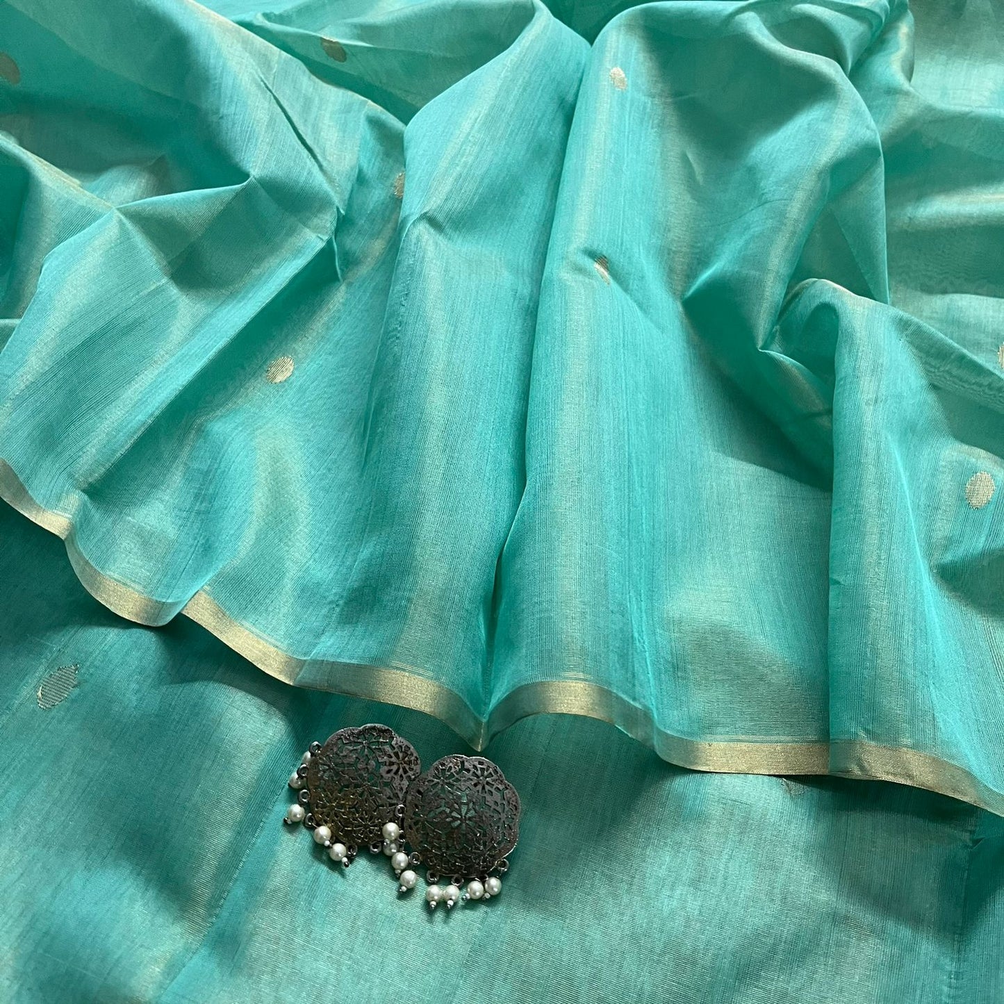 Turquoise maheshwari tissue silk saree with zari bootis all over