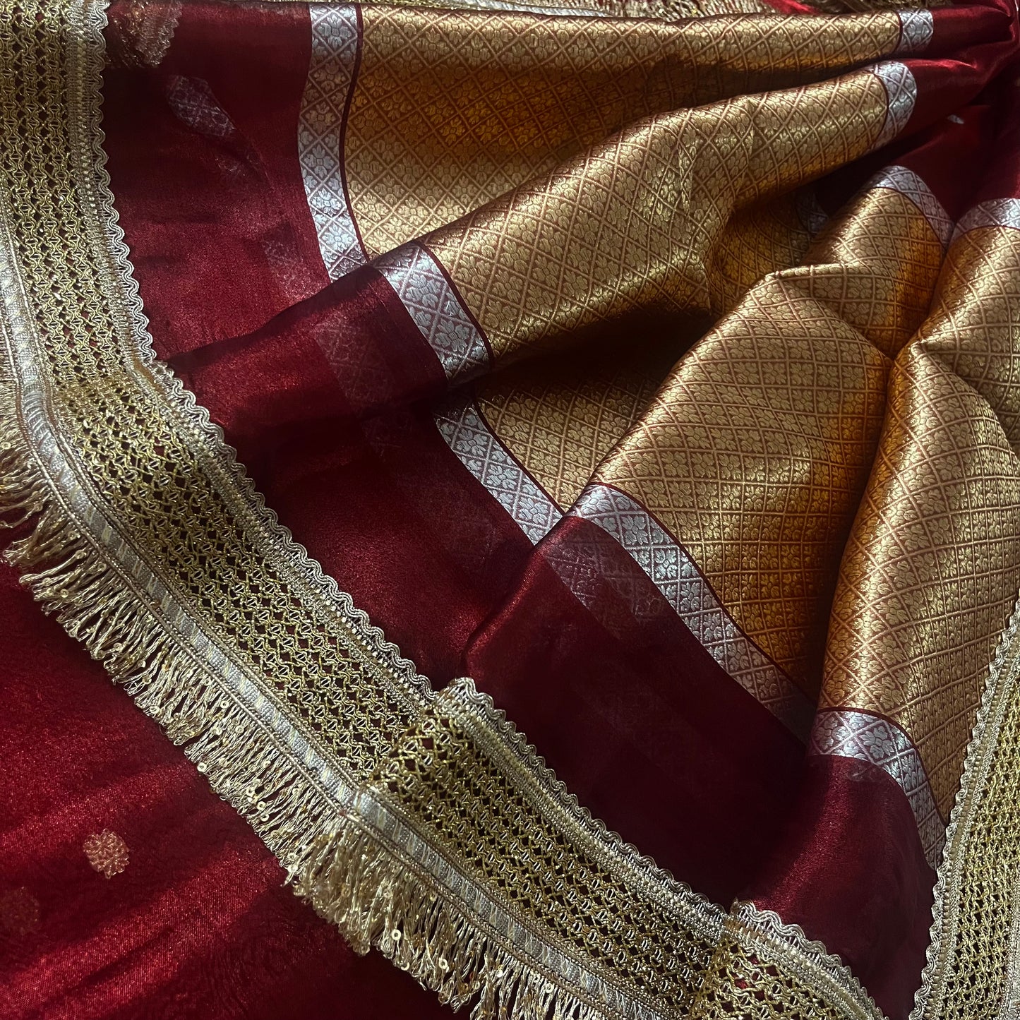 Maroon banarasi tissue silk saree with zari bootis and zari border