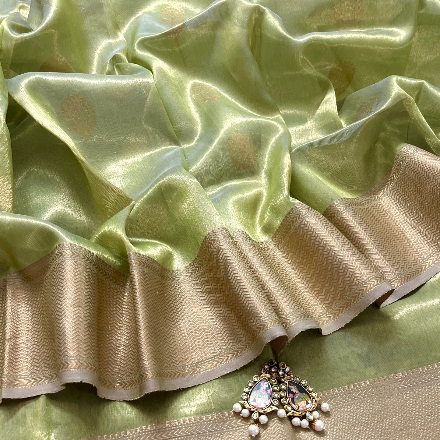 Green maheshwari tissue silk saree with flower motifs all over