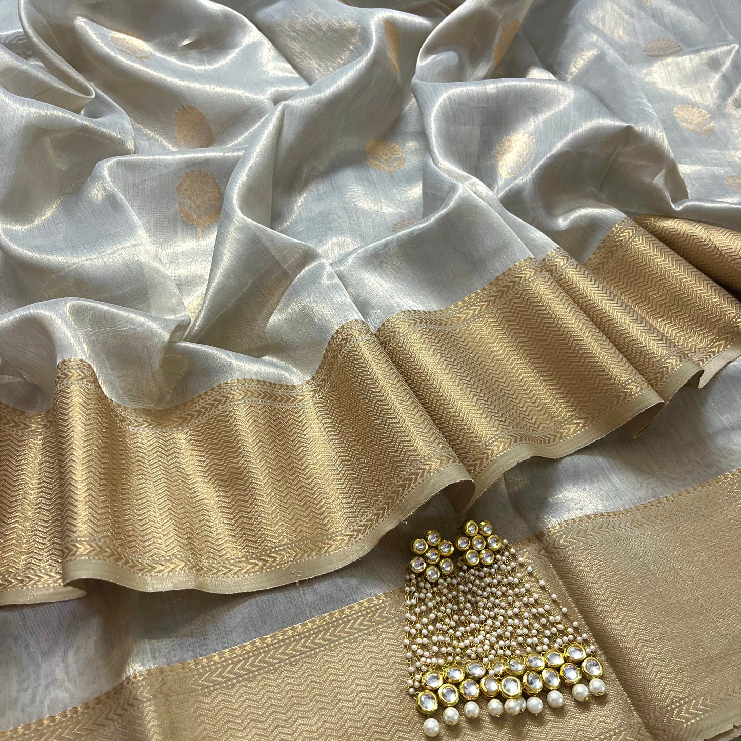 Silver gold maheshwari tissue silk saree with flower motifs all over