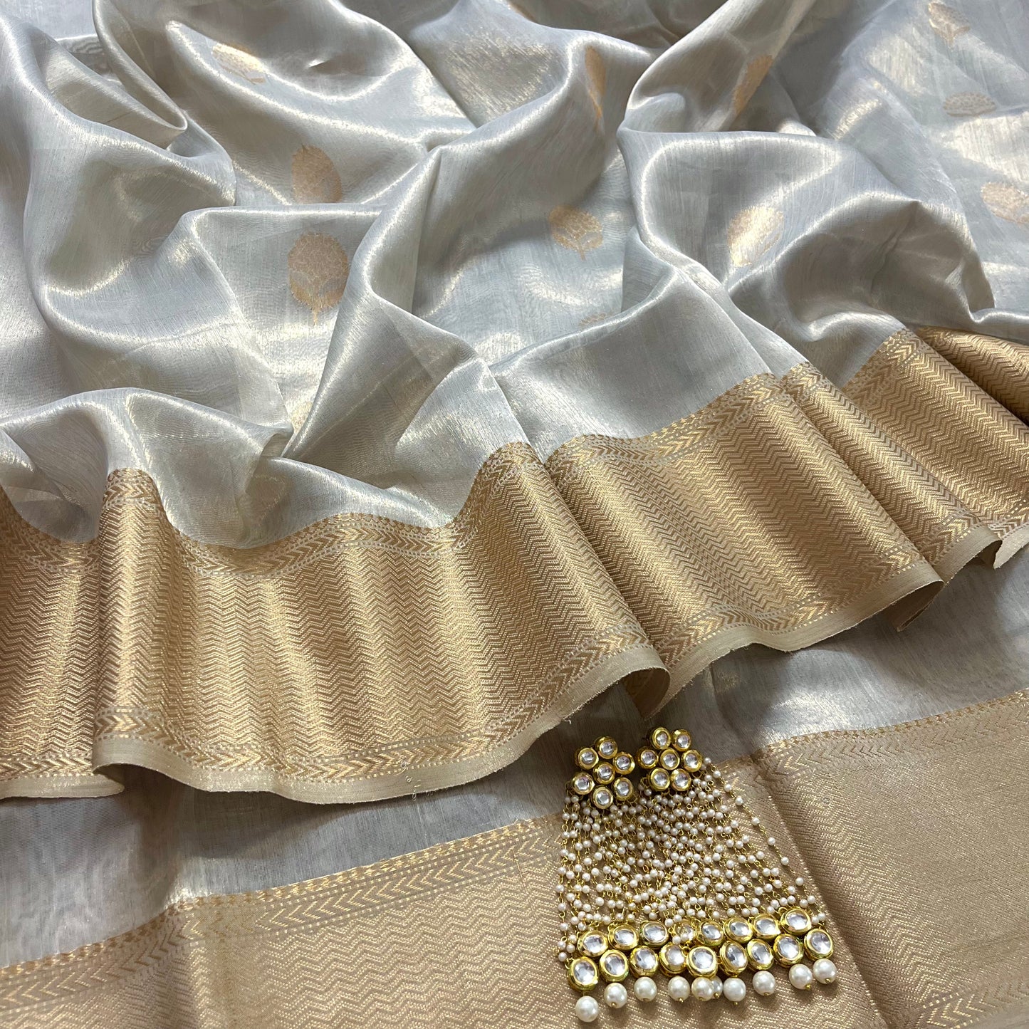 Silver gold maheshwari tissue silk saree with flower motifs all over