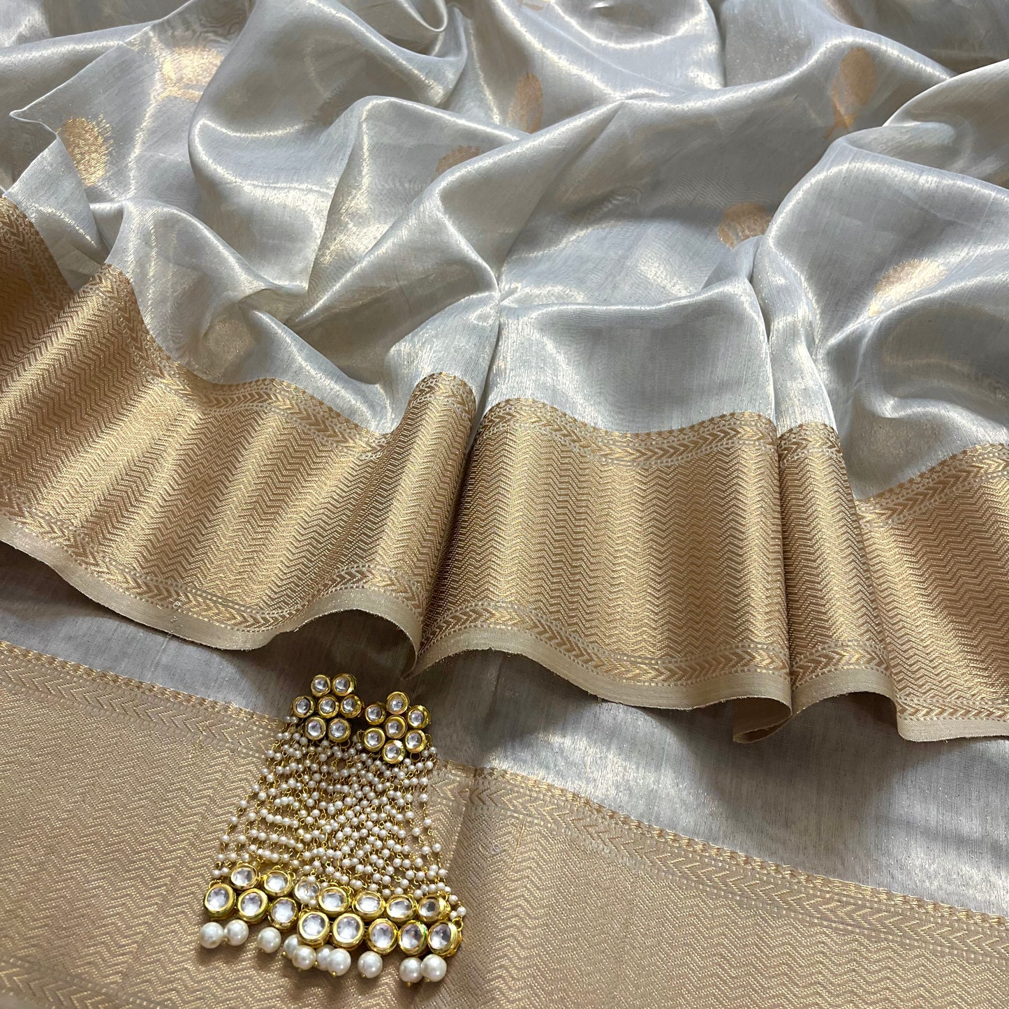 Silver gold maheshwari tissue silk saree with flower motifs all over