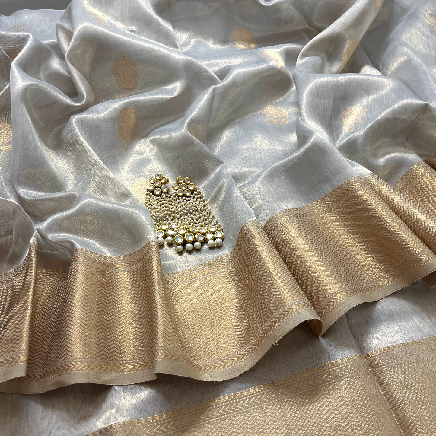 Silver gold maheshwari tissue silk saree with flower motifs all over