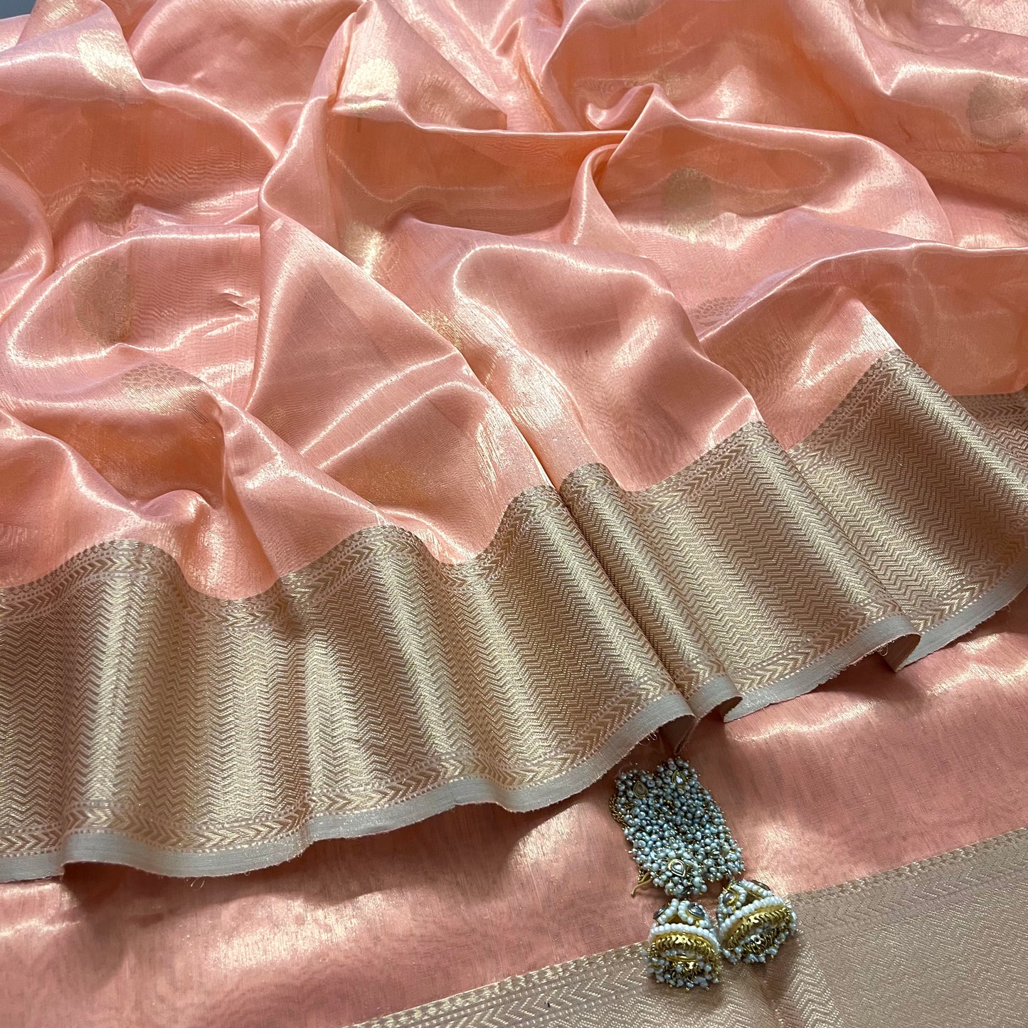 Peachish pink maheshwari tissue silk saree with flower motifs all over