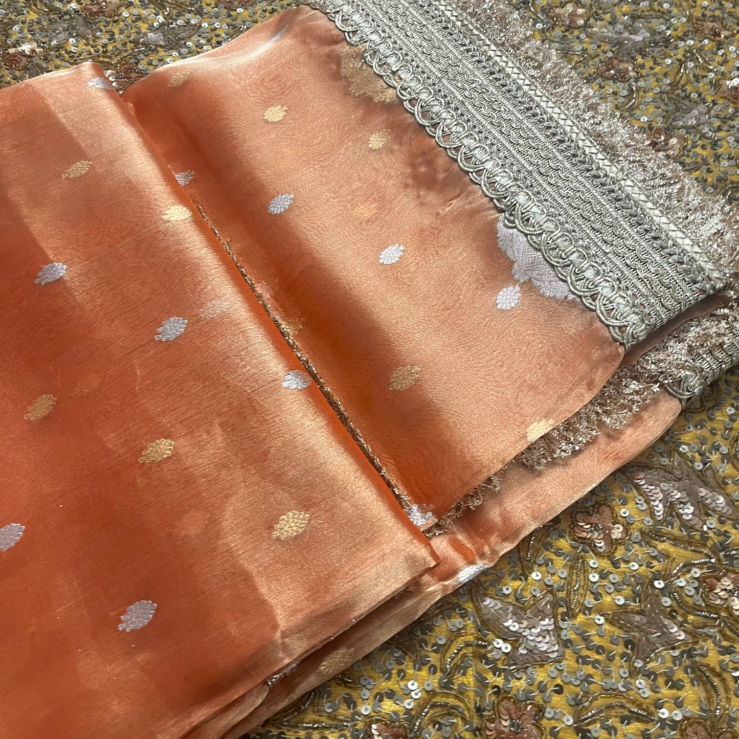 Rust orange banarasi tissue silk saree with zari bootis and zari border