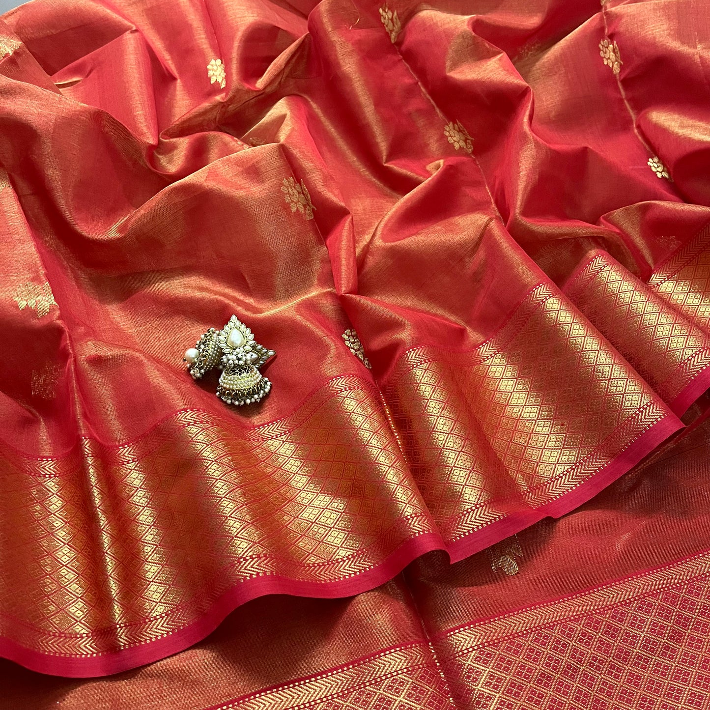 Red maheshwari tissue silk saree with flower motifs all over