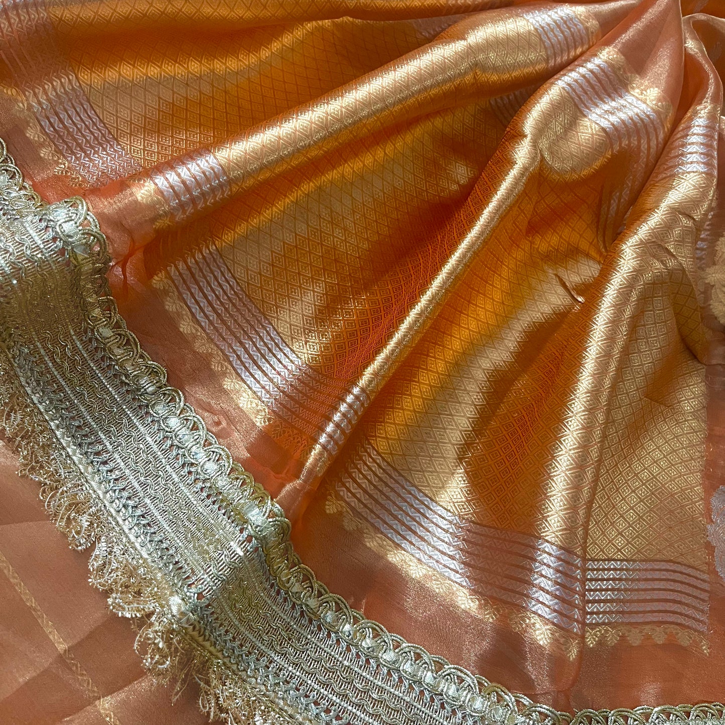 Rust orange banarasi tissue silk saree with zari bootis and zari border