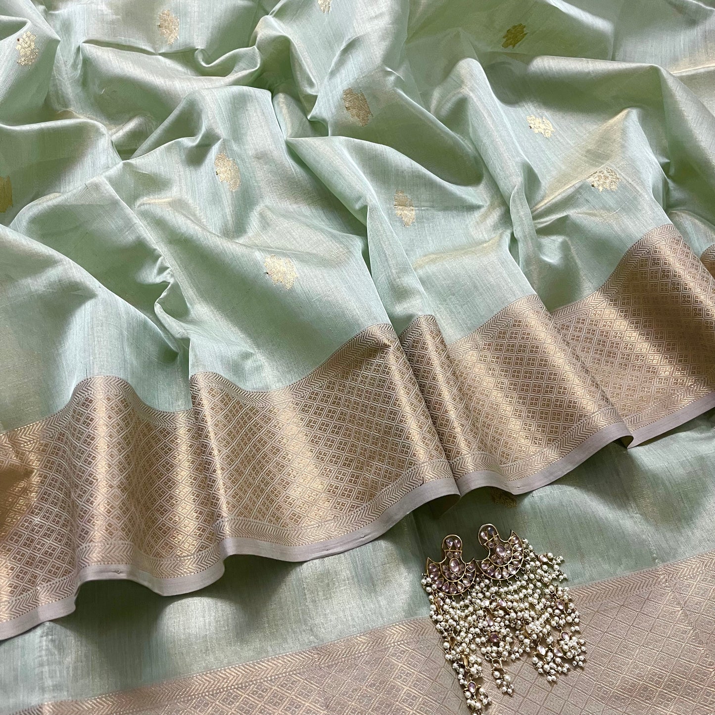 Sage green maheshwari tissue silk saree with flower motifs all over