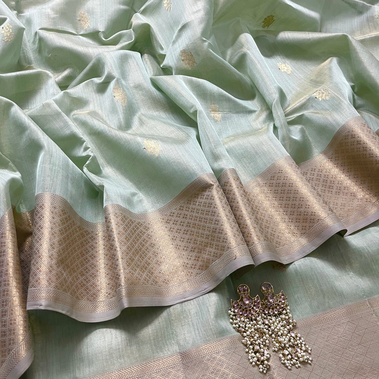 Sage green maheshwari tissue silk saree with flower motifs all over