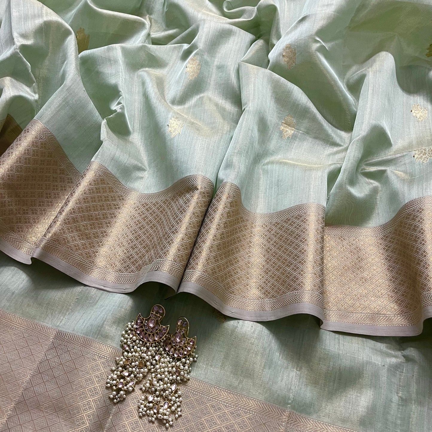 Sage green maheshwari tissue silk saree with flower motifs all over