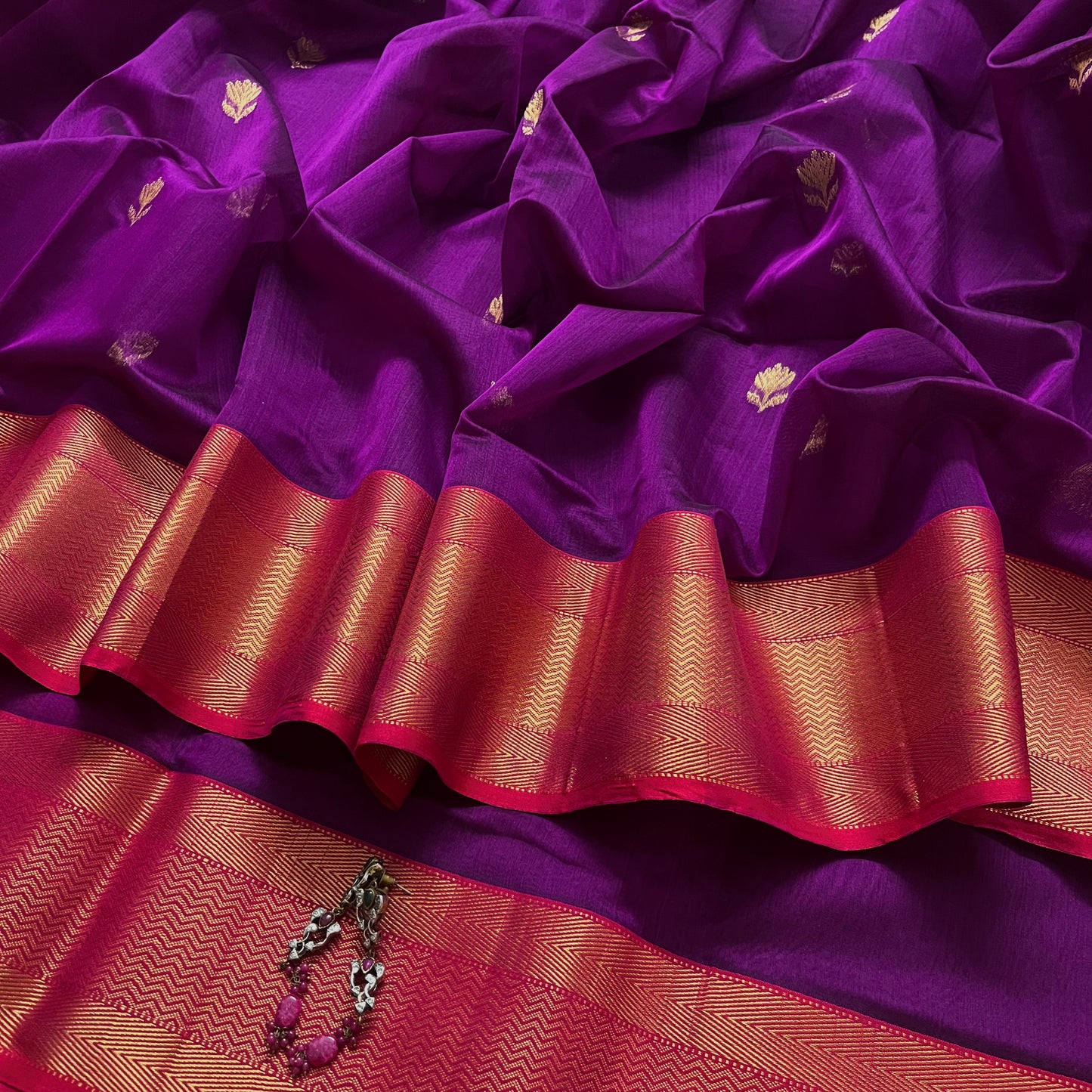 Violet and red maheshwari saree with flower motifs all over