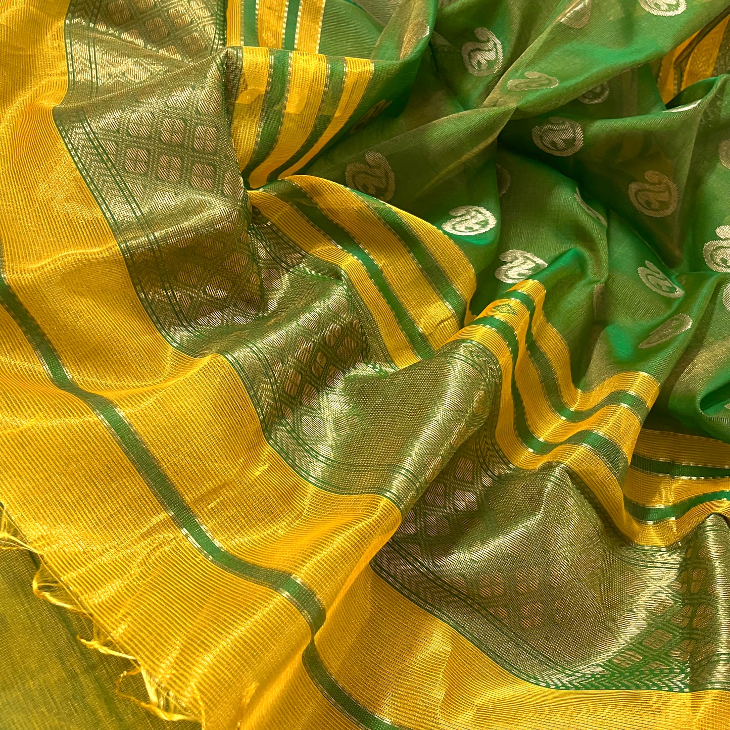 Yellow and green maheshwari tissue silk saree with zari bootis all over