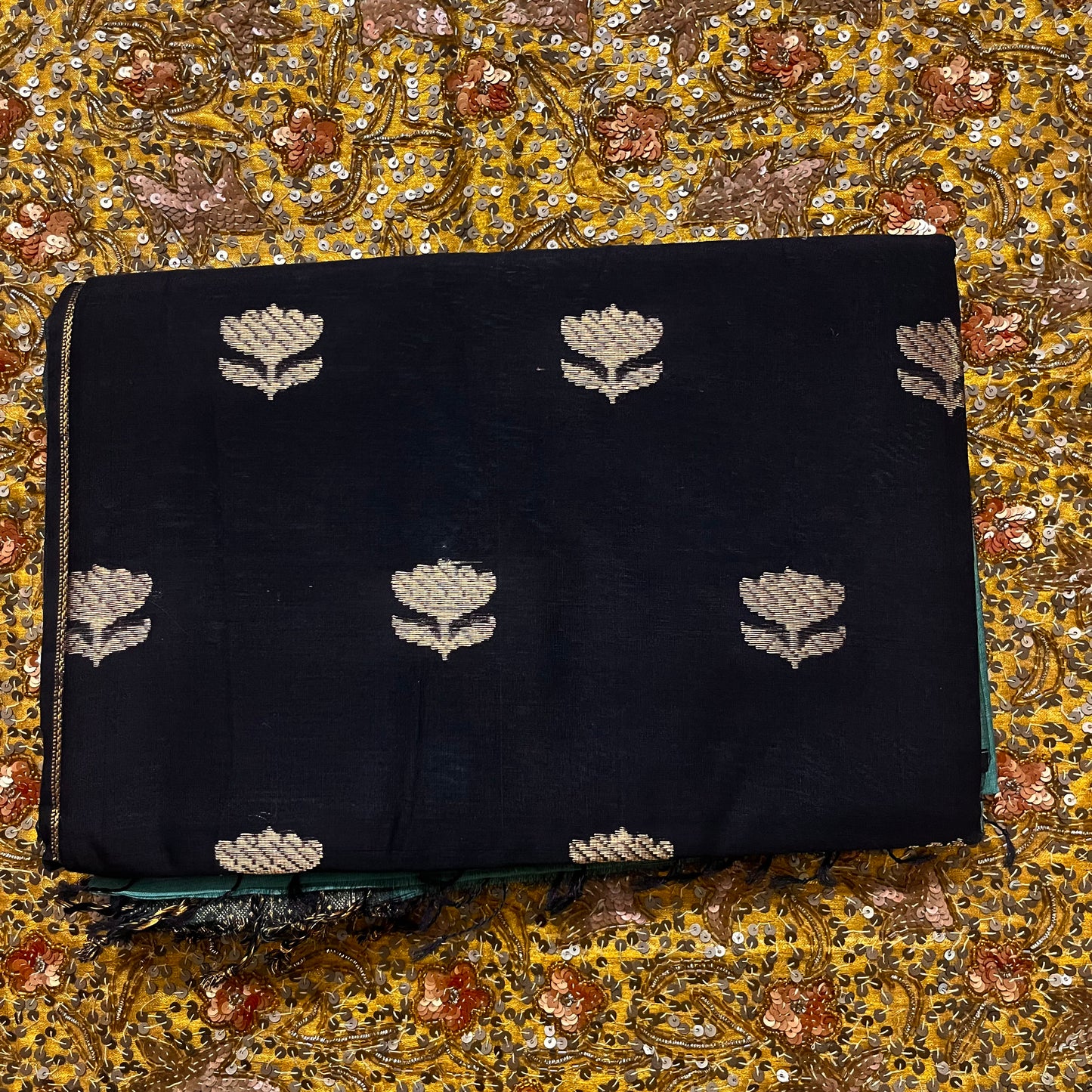 Turkish green and black maheshwari saree with flower motifs on pallu