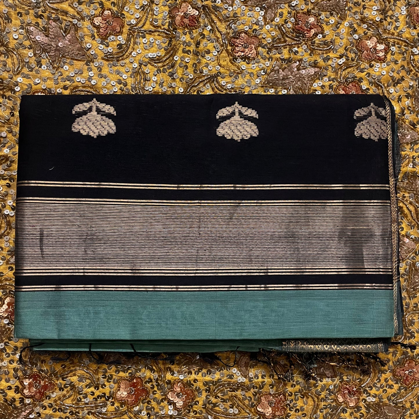 Turkish green and black maheshwari saree with flower motifs on pallu