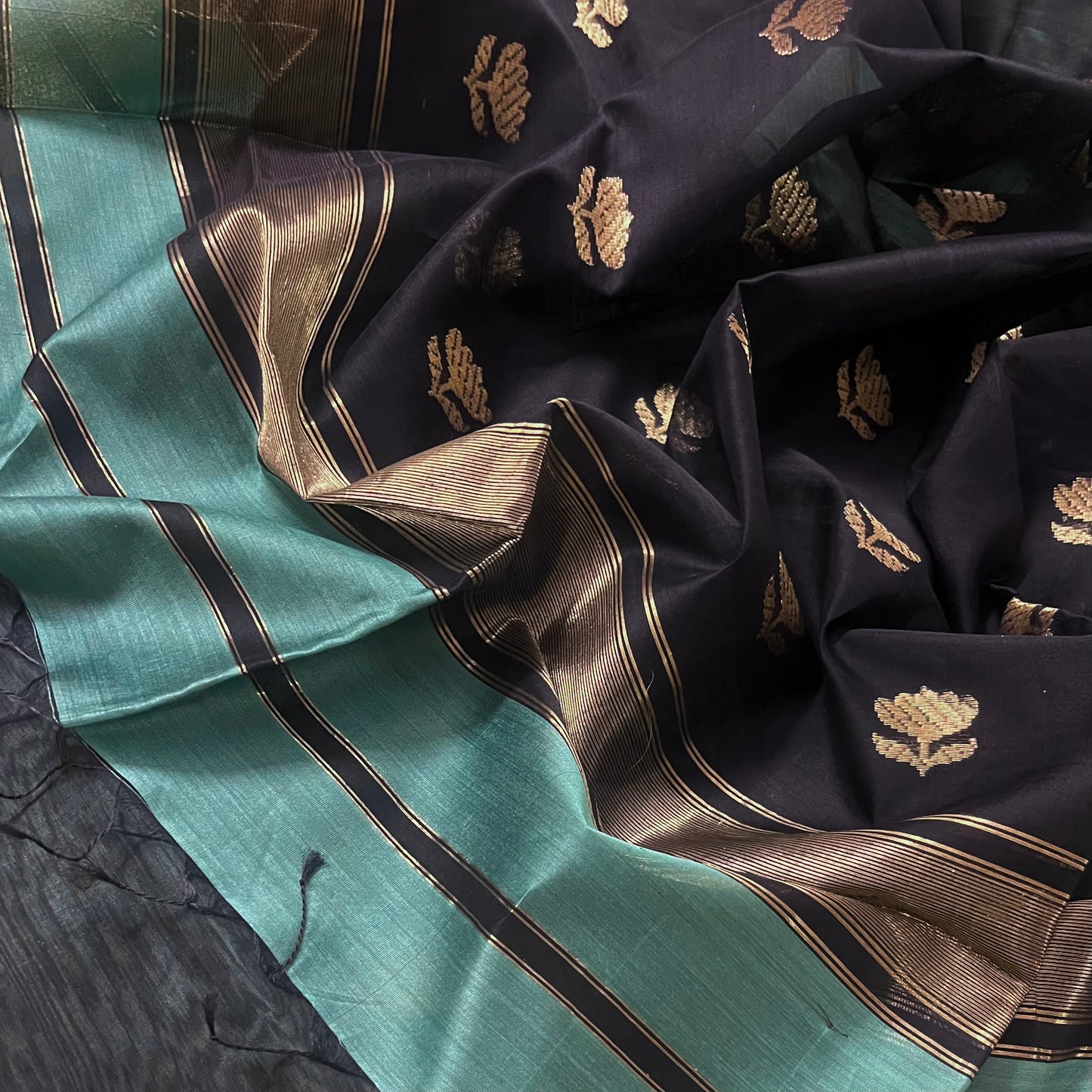 Turkish green and black maheshwari saree with flower motifs on pallu