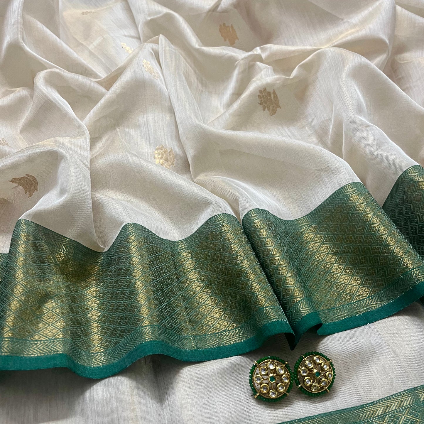 Off white green maheshwari tissue silk saree with flower motifs all over