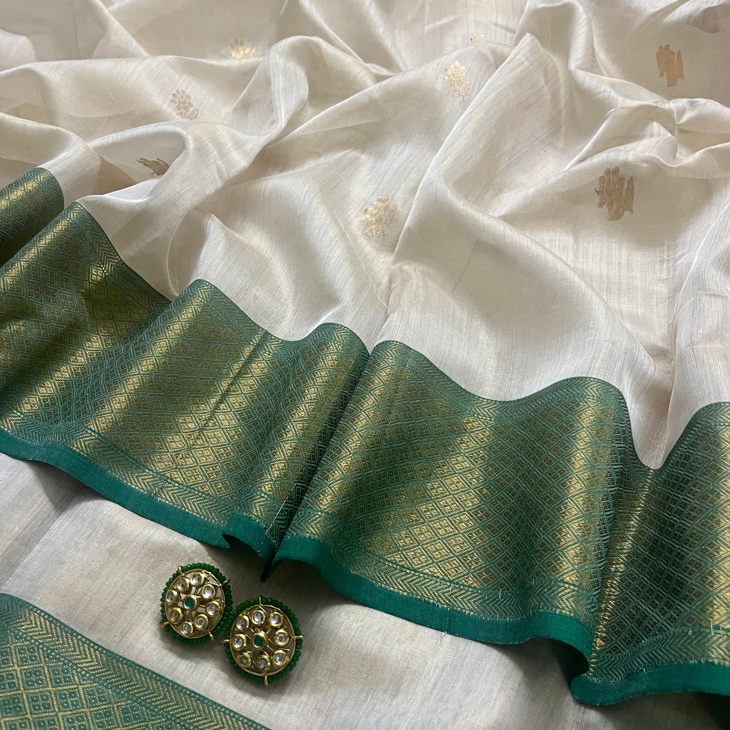 Off white green maheshwari tissue silk saree with flower motifs all over