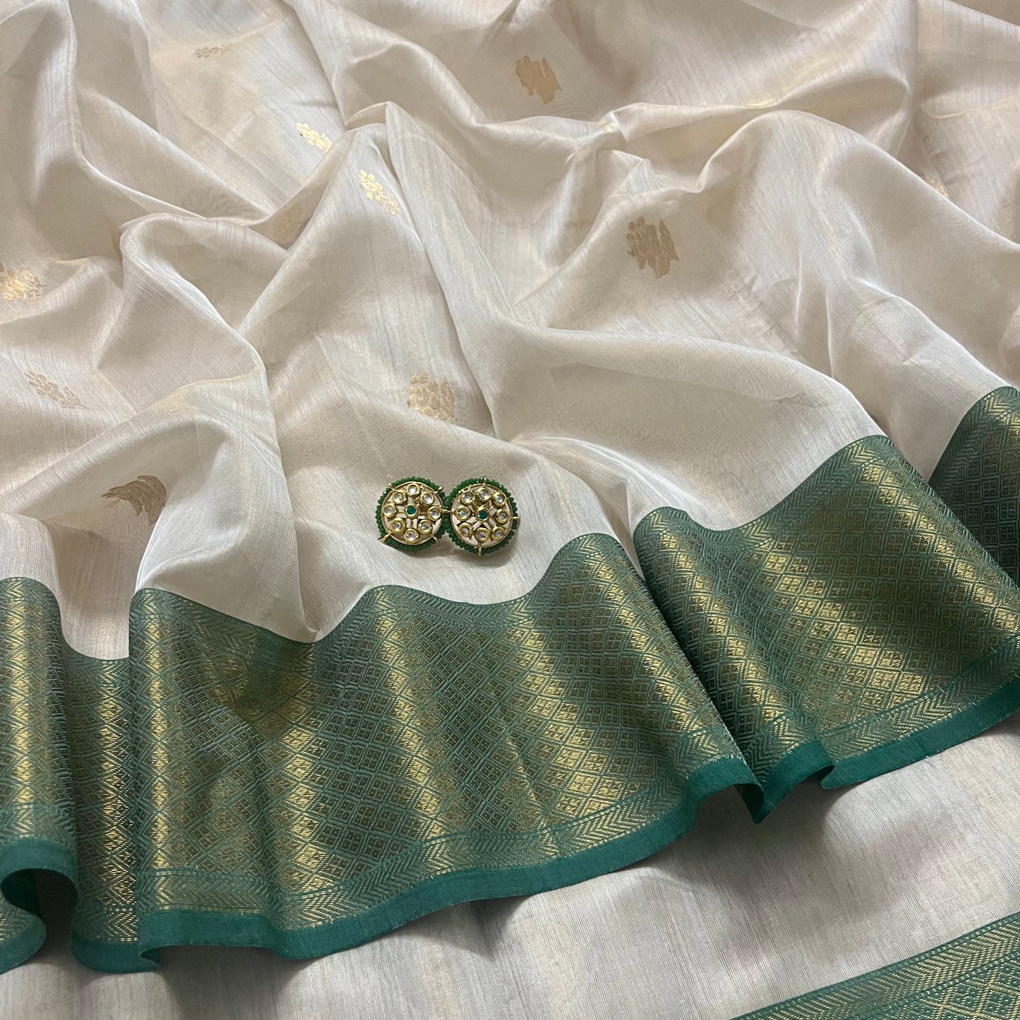 Off white green maheshwari tissue silk saree with flower motifs all over