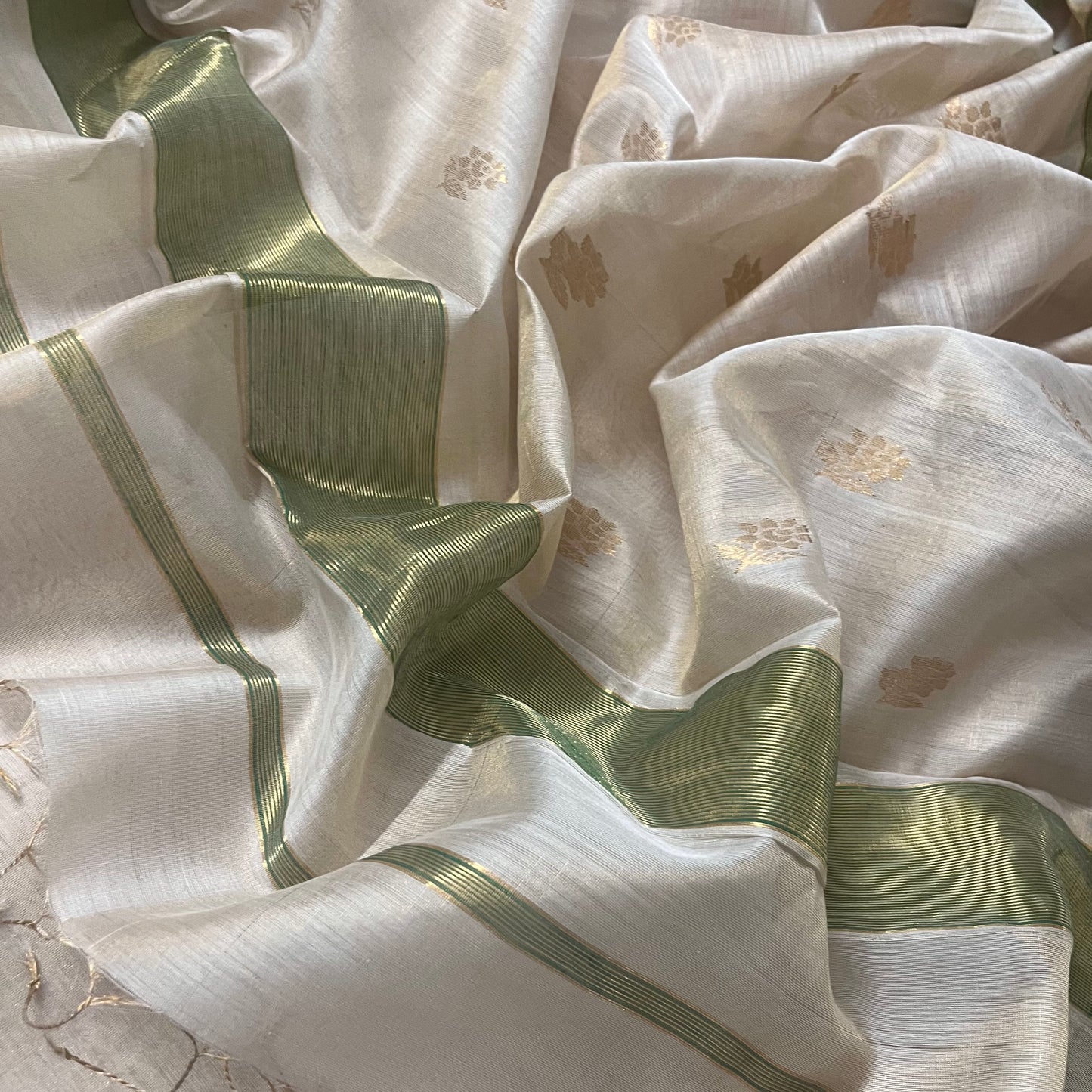 Off white green maheshwari tissue silk saree with flower motifs all over