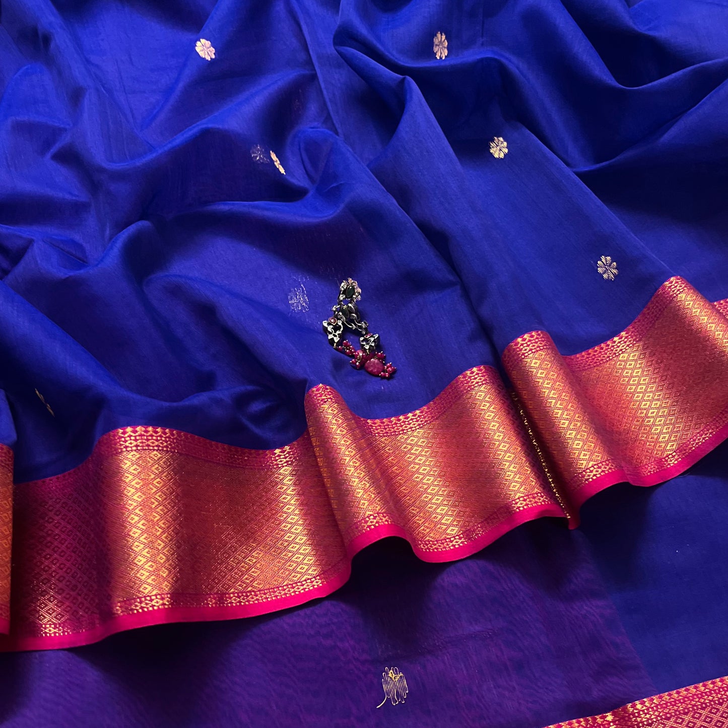 Dark blue and pink maheshwari saree with flower motifs on pallu