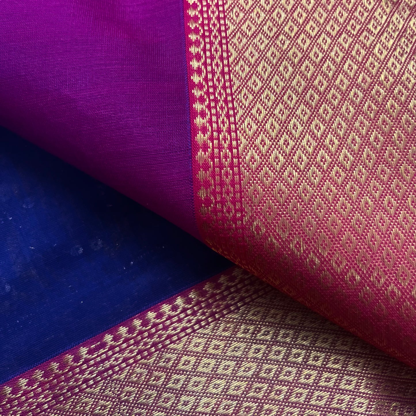 Dark blue and pink maheshwari saree with flower motifs on pallu