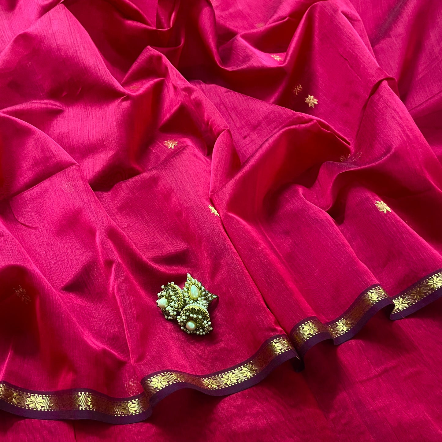 Deep pink maheshwari saree with flower bootis all over